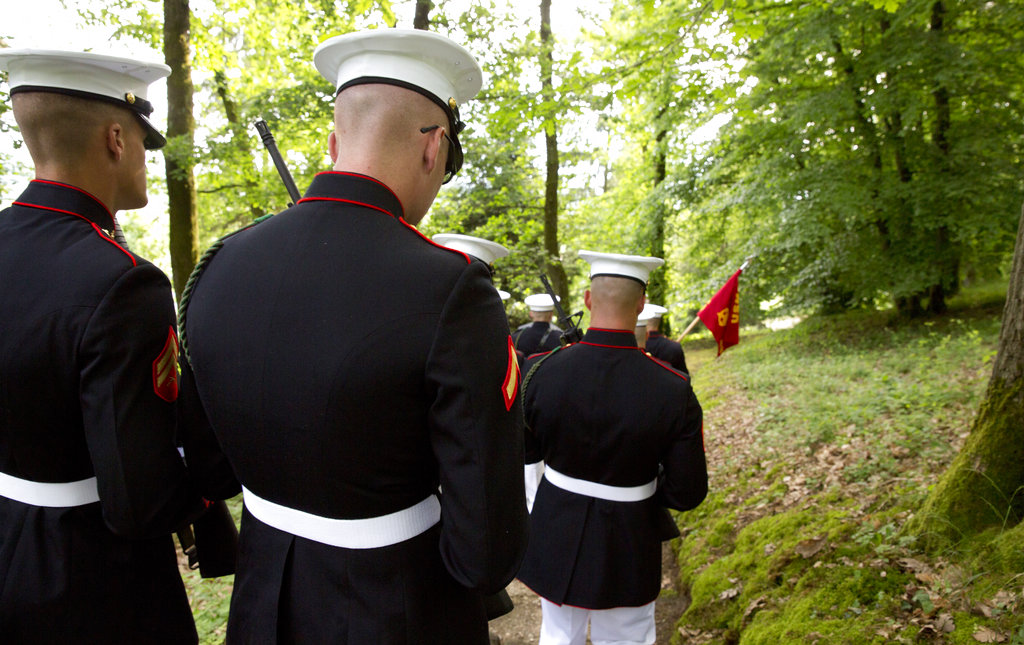 U.S. Marines walk through the battlefield of Belleau Wood prior to a Memorial Day commemoration at the Aisne-Marne American Cemetery in Belleau, France, Sunday, May 27, 2018. The cemetery contains more that 2,000 American dead. (Virginia Mayo/AP)