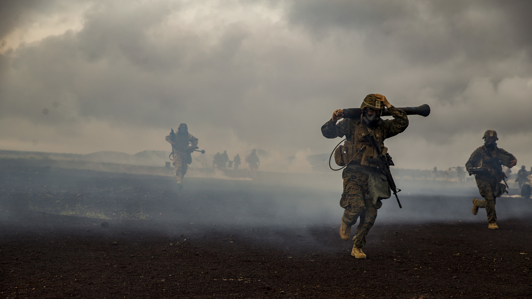 Marines with Weapons Company, 3rd Battalion, 3rd Marine Regiment, maneuver from a chemically gassed area during Exercise Bougainville II at the Pohakuloa Training Area, Hawaii, Oct. 20, 2018. (Sgt. Ricky Gomez/Marine Corps)