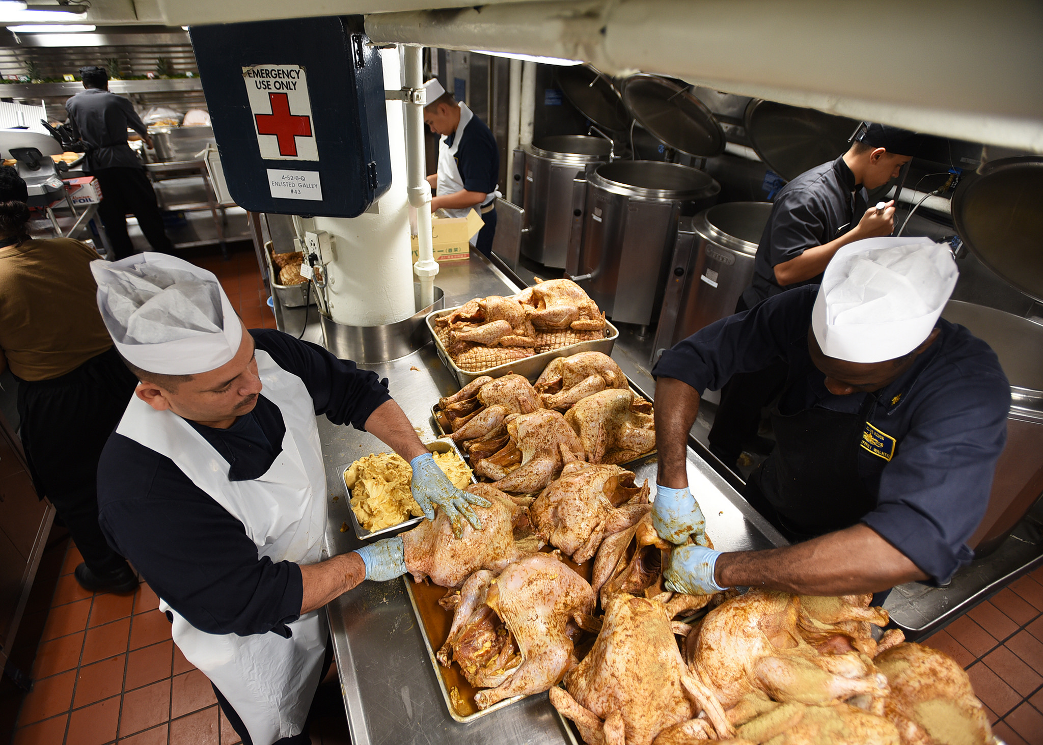 Sailors attached to the U.S. 7th Fleet flagship USS Blue Ridge (LCC 19) prepare turkeys for the ship's Thanksgiving celebration on Nov. 21, 2018, at Yokosuka, Japan. Navy culinary specialists across the fleet are preparing an estimated 112,000 pounds of roast turkey, 21,000 pounds of stuffing, 27,100 pounds of mashed potatoes, 18,500 pounds of sweet potatoes, 5,400 pounds of cranberry sauce, and 2,300 gallons of gravy. (MC3 Dylan McKay/Navy)