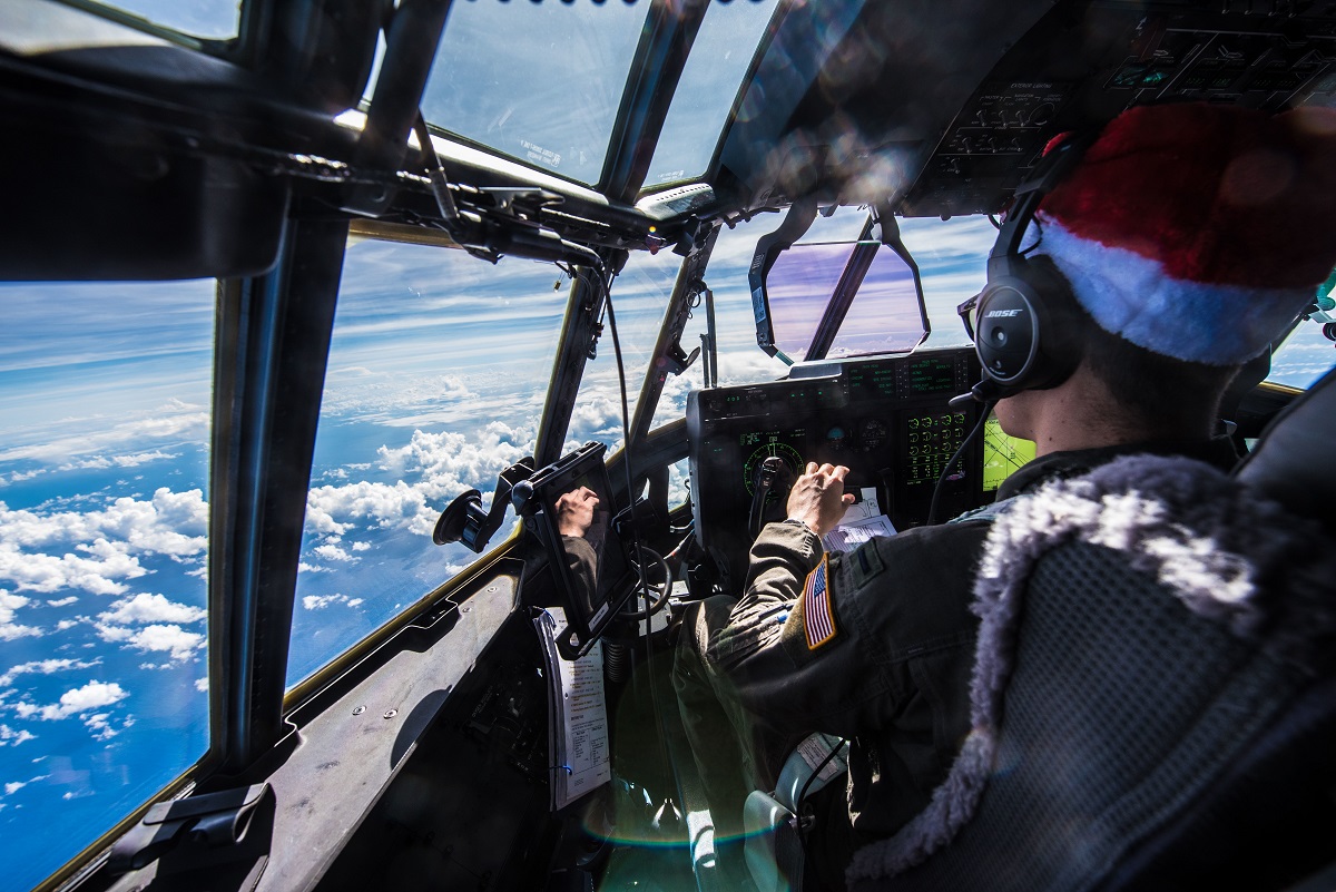 First Lt. Quinn Van Drew, C-130J first pilot assigned to the 36th Airlift Squadron, pilots his aircraft during Operation Christmas Drop, Dec. 15, 2017, above the Pacific Ocean near Guam. (Staff Sgt. Alexander W. Riedel/Air Force)