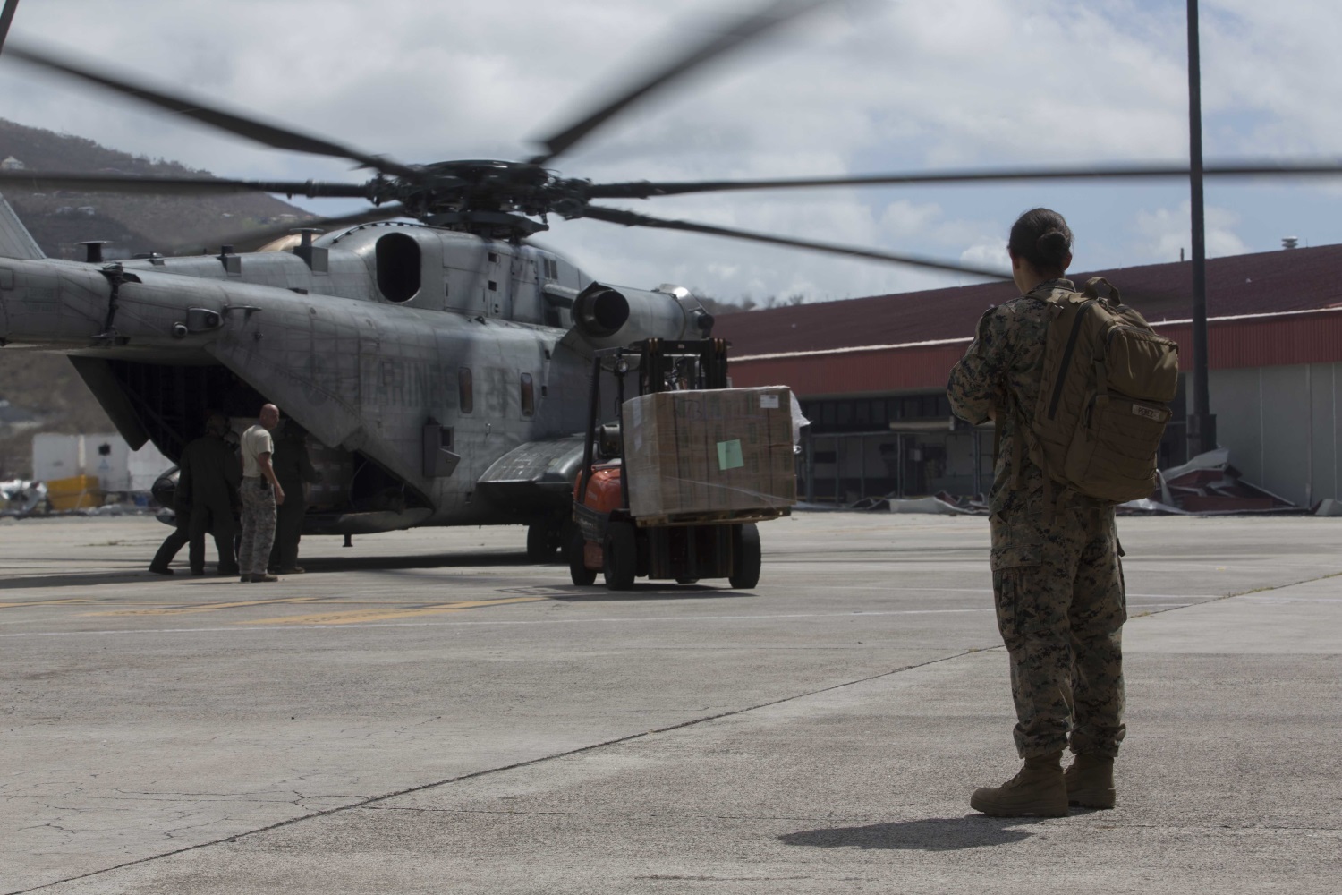 U.S. Marine Corps 1st Lt. Paloma D. Perezurena, a logistics officer with the 26th Marine Expeditionary Unit (MEU), observes U.S. Marines and U.S. Airmen unload humanitarian resources from a CH-53 Super Stallion helicopter with the 26th MEU, to support relief efforts in St. Thomas, U.S. Virgin Islands, Sep. 10, 2017. (Lance Cpl. Santino D. Martinez/Marine Corps)