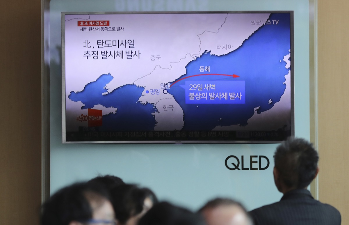 People sit in front of a TV showing reporting about North Korea's missile firing of a short-range Scud missile variant, known as KN-18. It demonstrated a new maneuvering capability for North Korea. The missile’s first test is thought to be a success, flying 450 kilometers before landing in the Sea of Japan. (Lee Jin-man/AP)