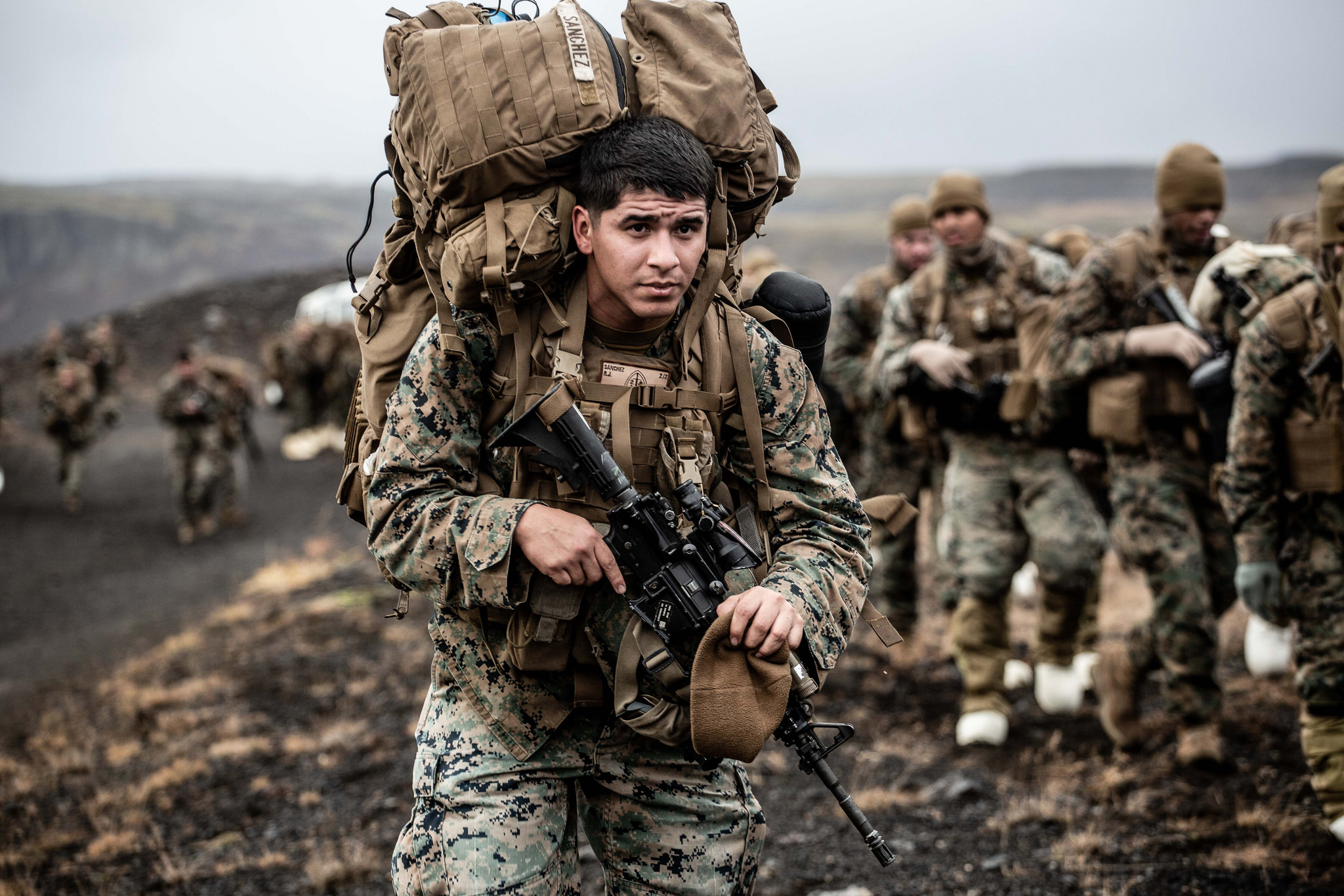 A Marine with the 24th Marine Expeditionary Unit carries cold weather equipment as he begins to march across the Icelandic terrain Oct. 19, 2018. The 24th MEU was in Iceland preparing for NATO Exercise Trident Juncture 2018. (Capt. Kylee Ashton/Air Force)