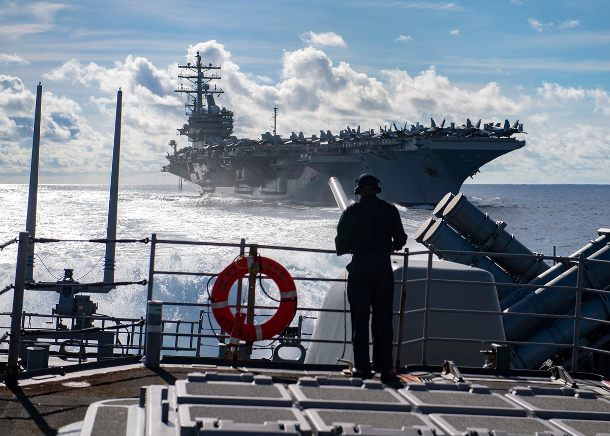 Seaman Marcus White stands watch as aft lookout aboard the Ticonderoga-class guided-missile cruiser USS Chancellorsville (CG 62) on June 30, 2019, during a replenishment-at-sea with the Nimitz-class aircraft carrier USS Ronald Reagan (CVN 76) in the Philippine Sea. (Mass Communication Specialist 2nd Class John Harris/Navy)