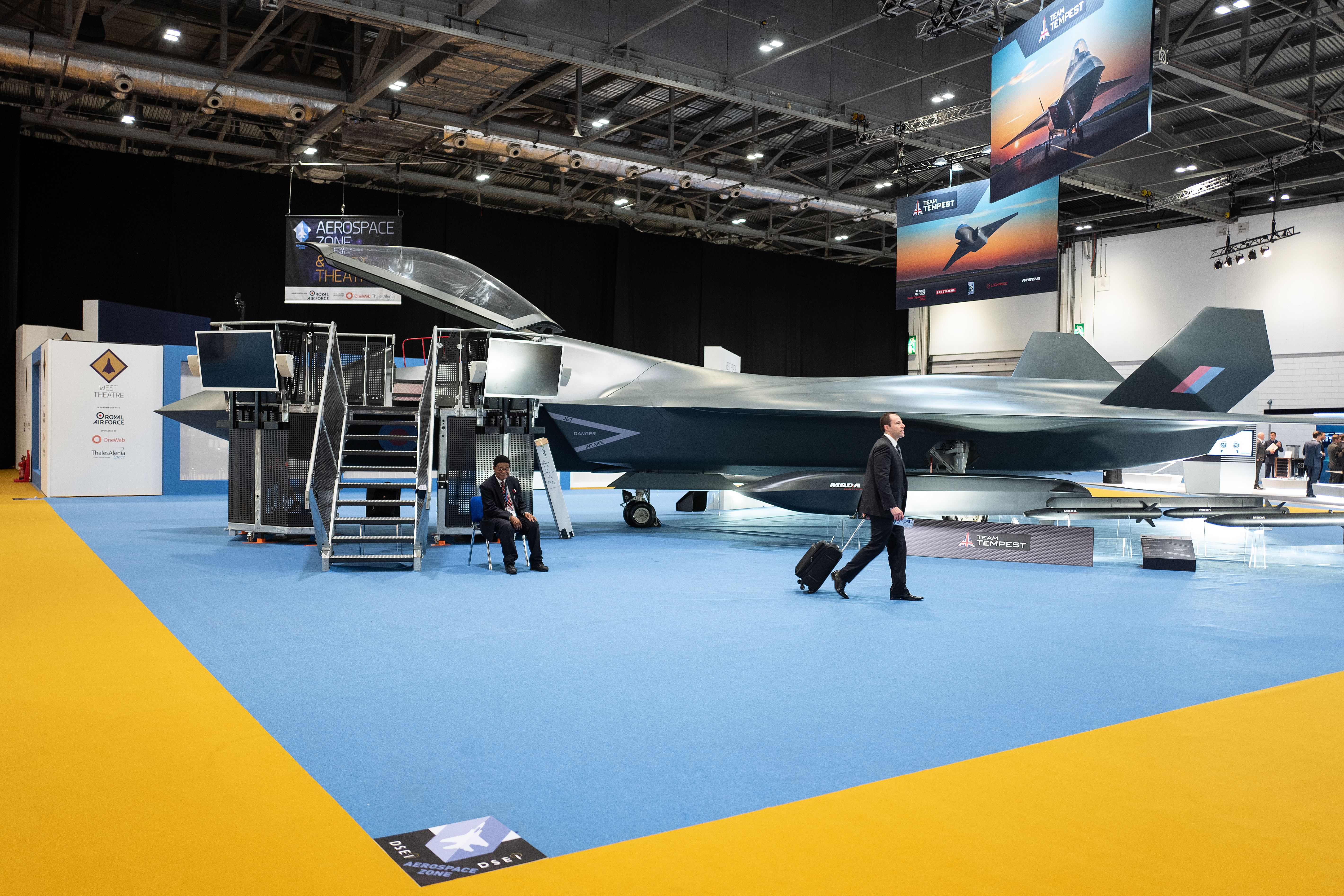 At the DSEI arms fair, a delegate walks past a model of the BAE Systems Tempest fighter jet. (Leon Neal/Getty Images)