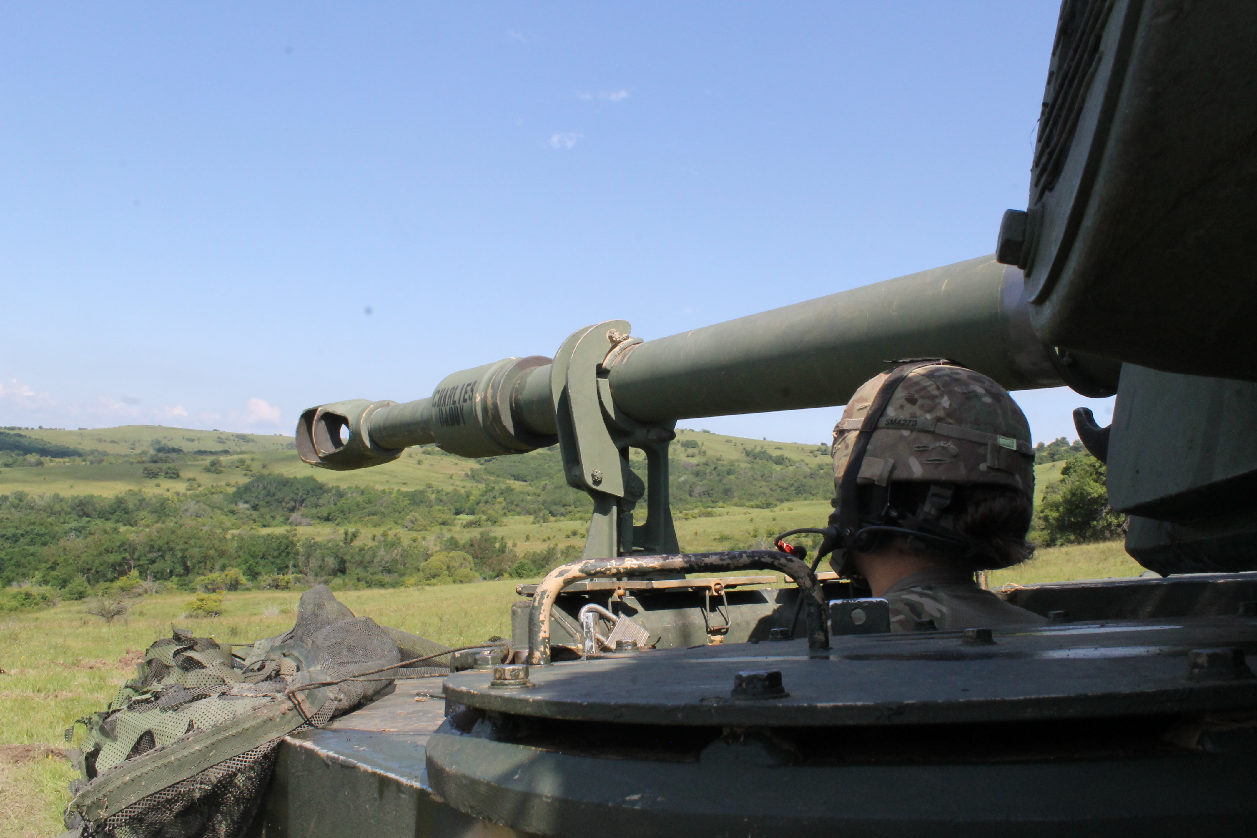 The driver of a Paladin looks out over the hillside where the howitzers took position for the exercise. The Paladin’s range was demonstrated during the live-fire event in an effort to suppress enemy assets to allow freedom of movement of infantry soldiers, Bradleys and M1 Abrams tanks to move in and assault the enemy. The High Mobility Artillery Rocket System and the Multiple Launch Rocket System joined in the salvo of fire power from distant hillsides overlooking the battle space. (Jen Judson/Staff)