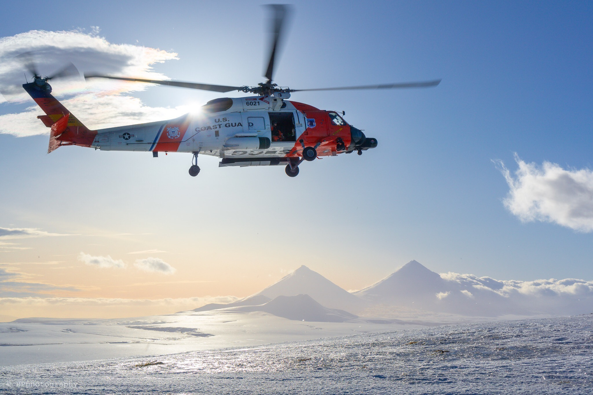 A U.S. Coast Guard MH-60 Jayhawk helicopter assigned to Air Station Kodiak flies over an active volcano near Cold Bay, Alaska, Feb. 7, 2019. (Petty Officer 1st Class Bradley Pigage/Coast Guard)