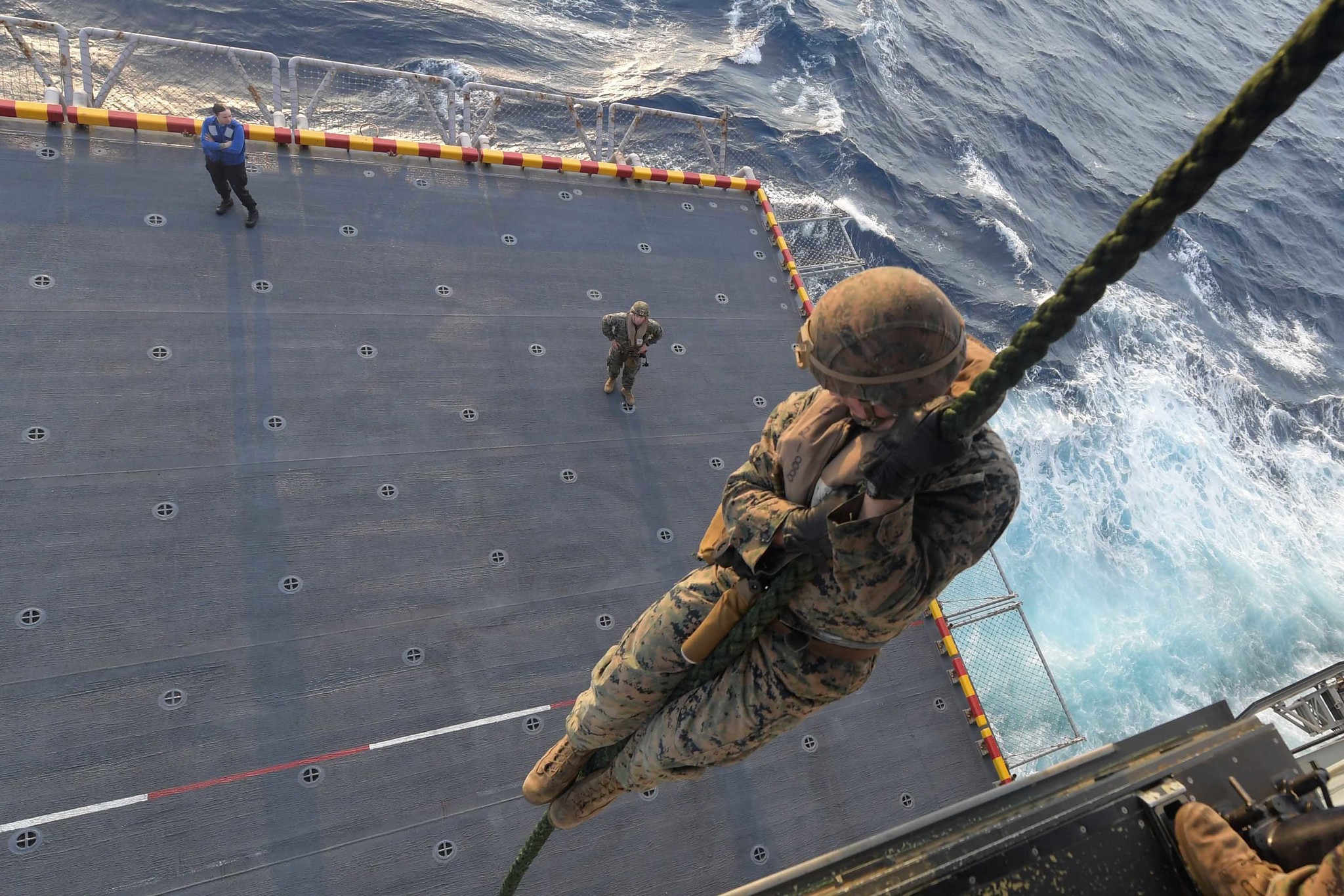 Marines perform a fast rope exercise on the port aircraft elevator of the amphibious assault ship USS America (LHA 6) on Feb. 18, 2020, in the South China Sea. (Mass Communication Specialist Seaman Jomark A. Almazan/Navy)