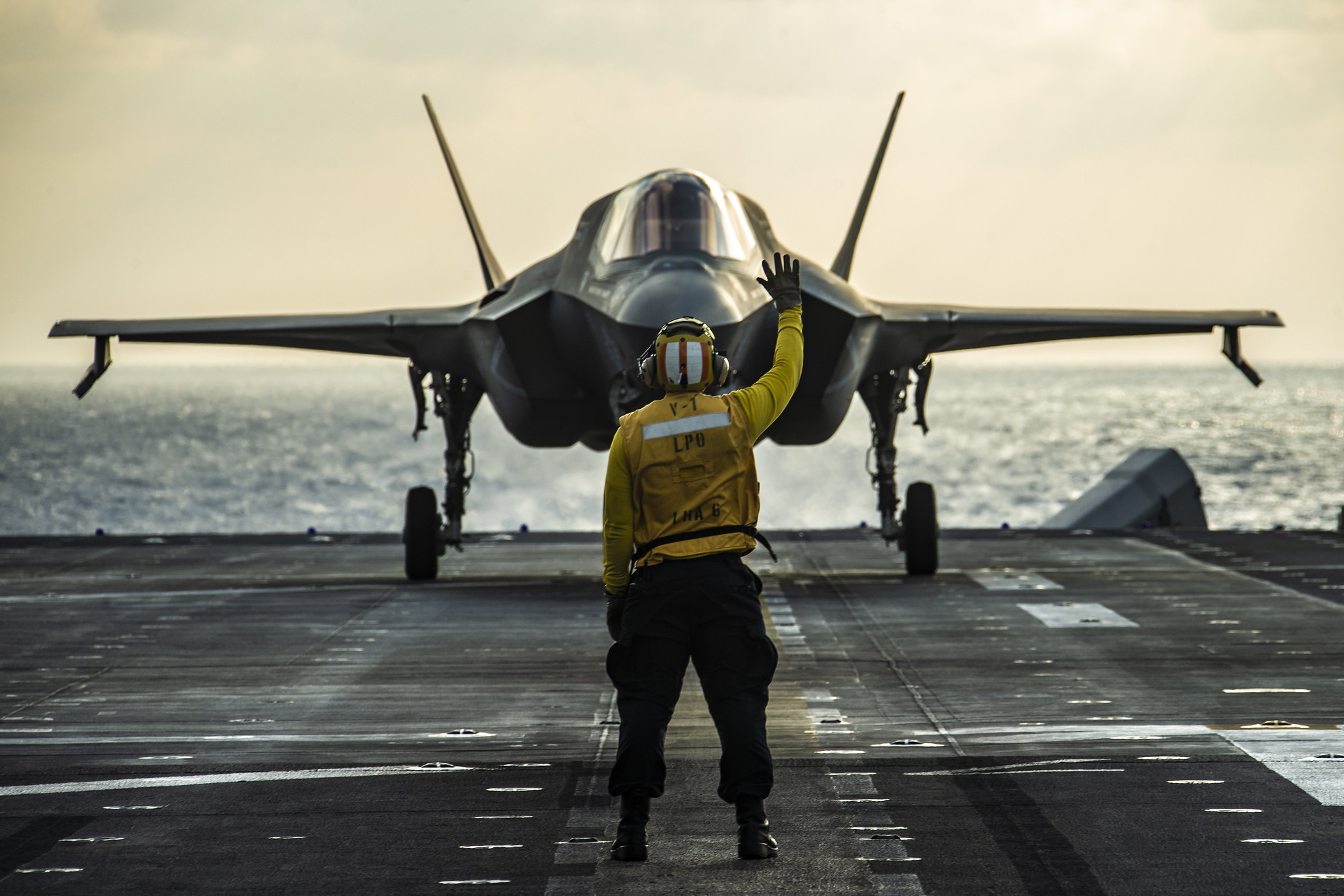 An F-35B Lightning II fighter aircraft prepares to take off from the flight deck of amphibious assault ship USS America (LHA 6) on March 25, 2020, prior to a strike exercise of an inflatable maritime target in the Philippine Sea. (Lance Cpl. Joshua Brittenham/Marine Corps