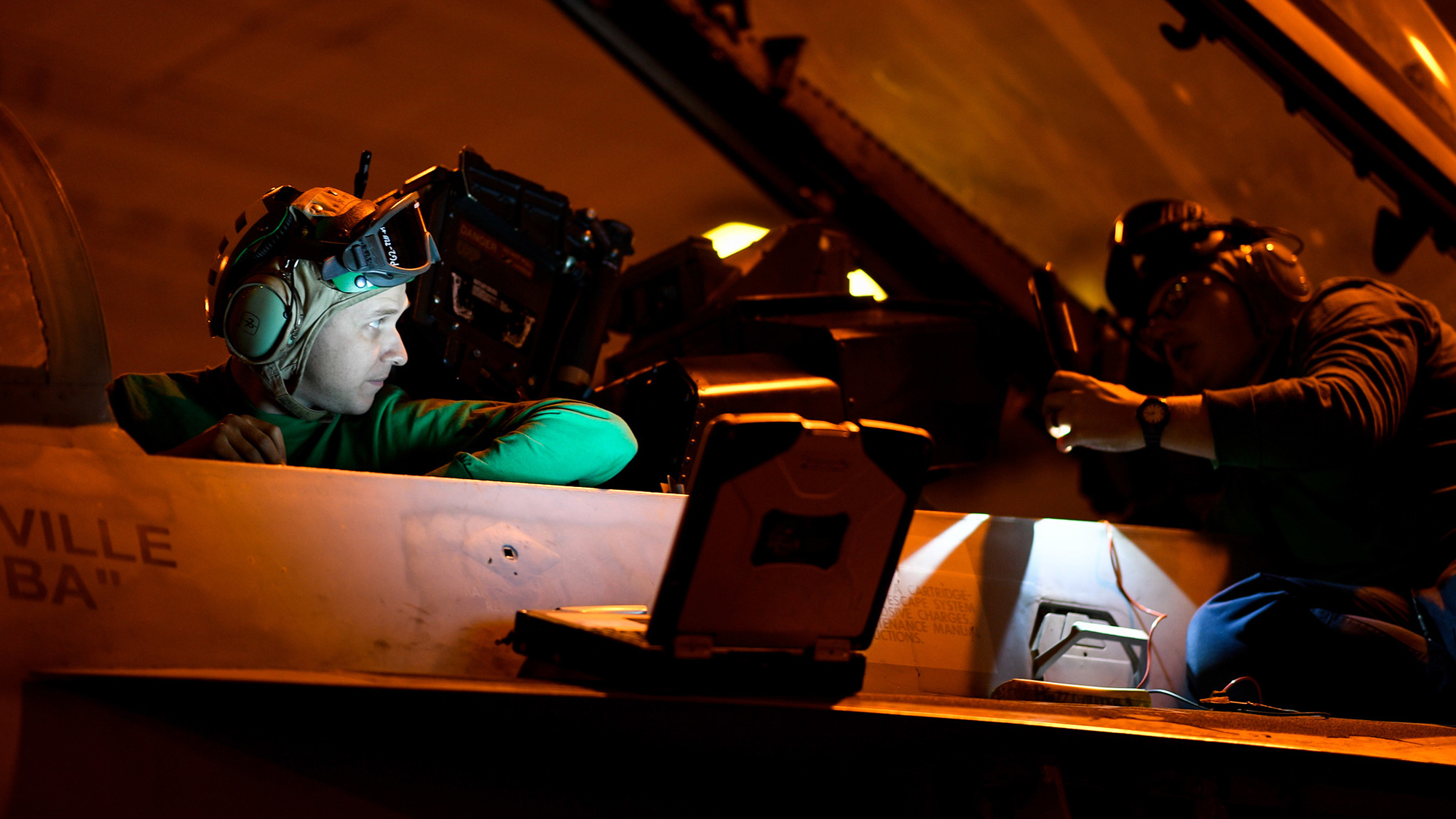 Aviation Electrician’s Mate 2nd Class Trevor Brewster, left, and Aviation Electrician’s Mate 3rd Class Caleb Byers run diagnostics on the weapons system of an F/A-18F Super Hornet on Nov. 20, 2019, in the hangar bay of the aircraft carrier USS Theodore Roosevelt (CVN 71) in the Pacific Ocean. (Mass Communication Specialist Seaman Olympia O. McCoy/Navy)
