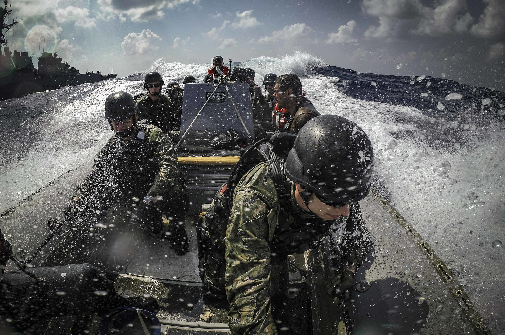 U.S. sailors maneuver a rigid-hull inflatable boat alongside the Arleigh Burke-class guided-missile destroyer USS Carney (DDG 64) while participating in visit, board, search and seizure training Sept. 10, 2018, during Exercise Bright Star 2018 in the Mediterranean Sea. (MC1 Ryan U. Kledzik/Navy)