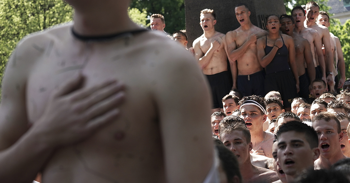 Members of the freshman class sing the Navy Blue and Gold at the end of the annual Herndon Monument Climb May 21, 2018 at the U.S. Naval Academy in Annapolis, Maryland. The first year midshipmen formed and climbed a human pyramid around the 21-foot-tall Herndon Monument, which was covered with about 50 pounds of vegetable shortening, to replace the plebe hat, also known as a