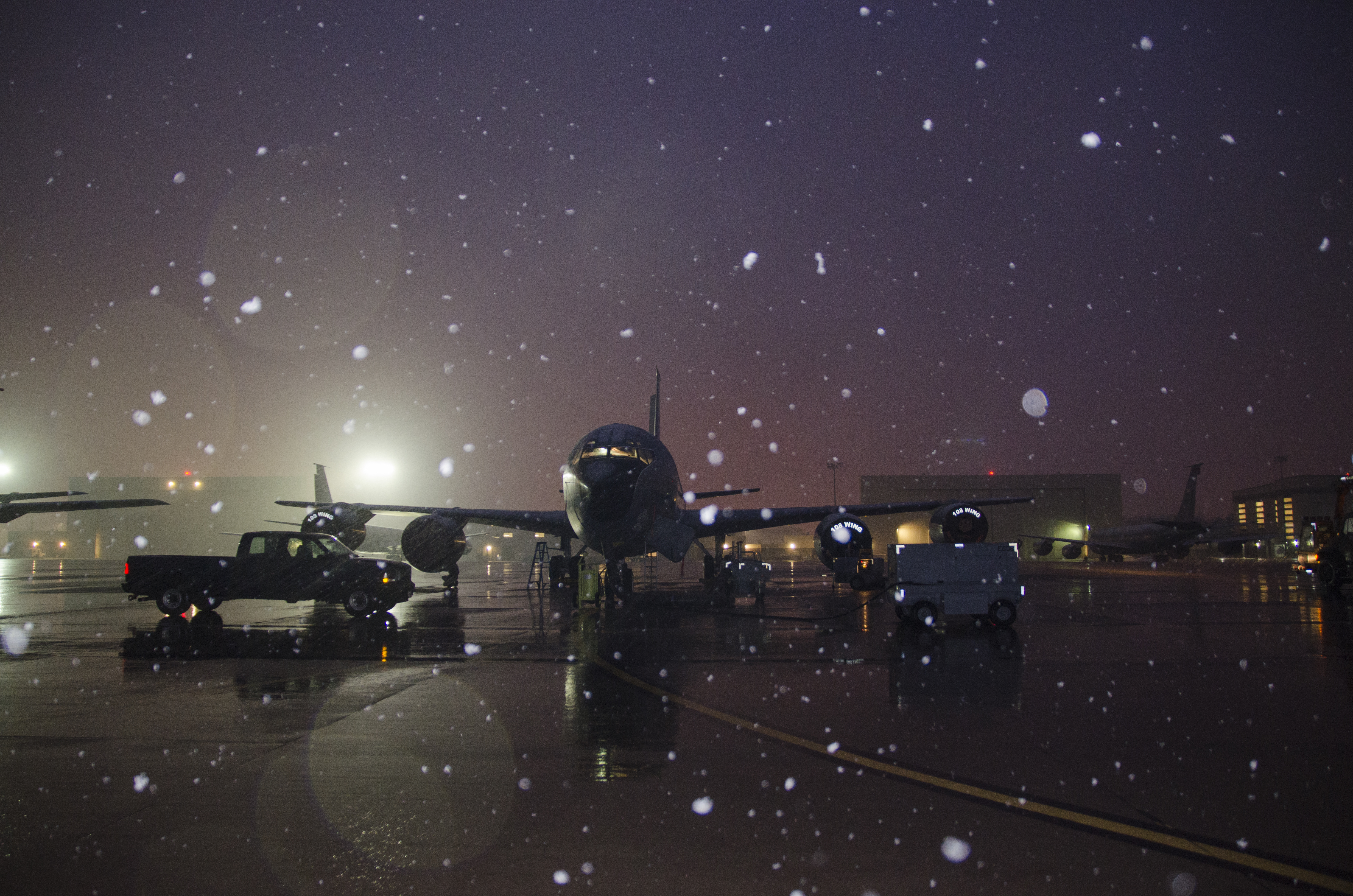 Snow falls as a 141st Air Refueling Squadron KC135R is prepped on the flightline at Joint Base McGuire-Dix-Lakehurst, N.J., Jan. 17, 2018. (Staff Sgt. Ross A. Whitley/Air National Guard)