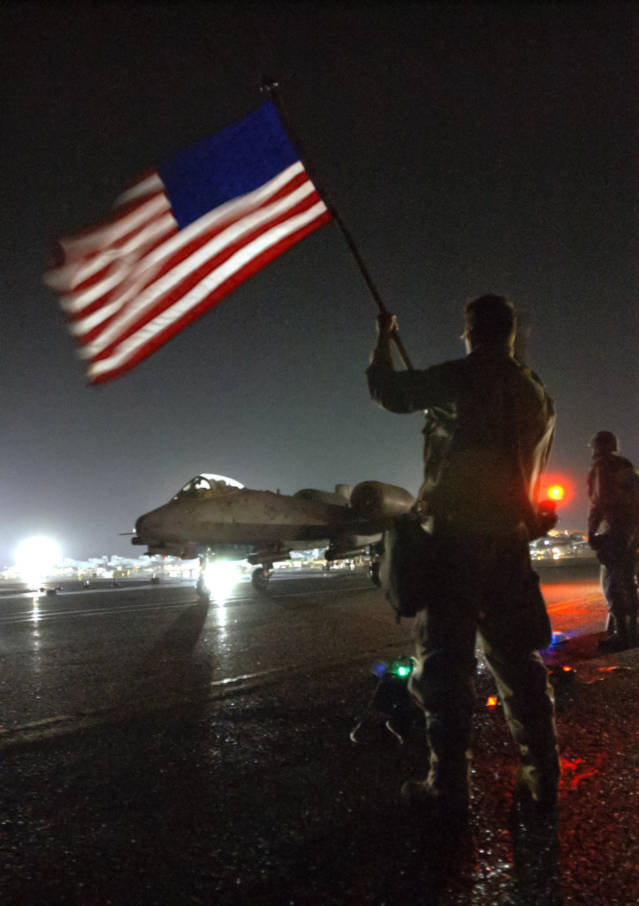 First Sgt. Kent Fuller from the 332nd Expeditionary Maintenance Squadron at an undisclosed air base in the middle east, waves his