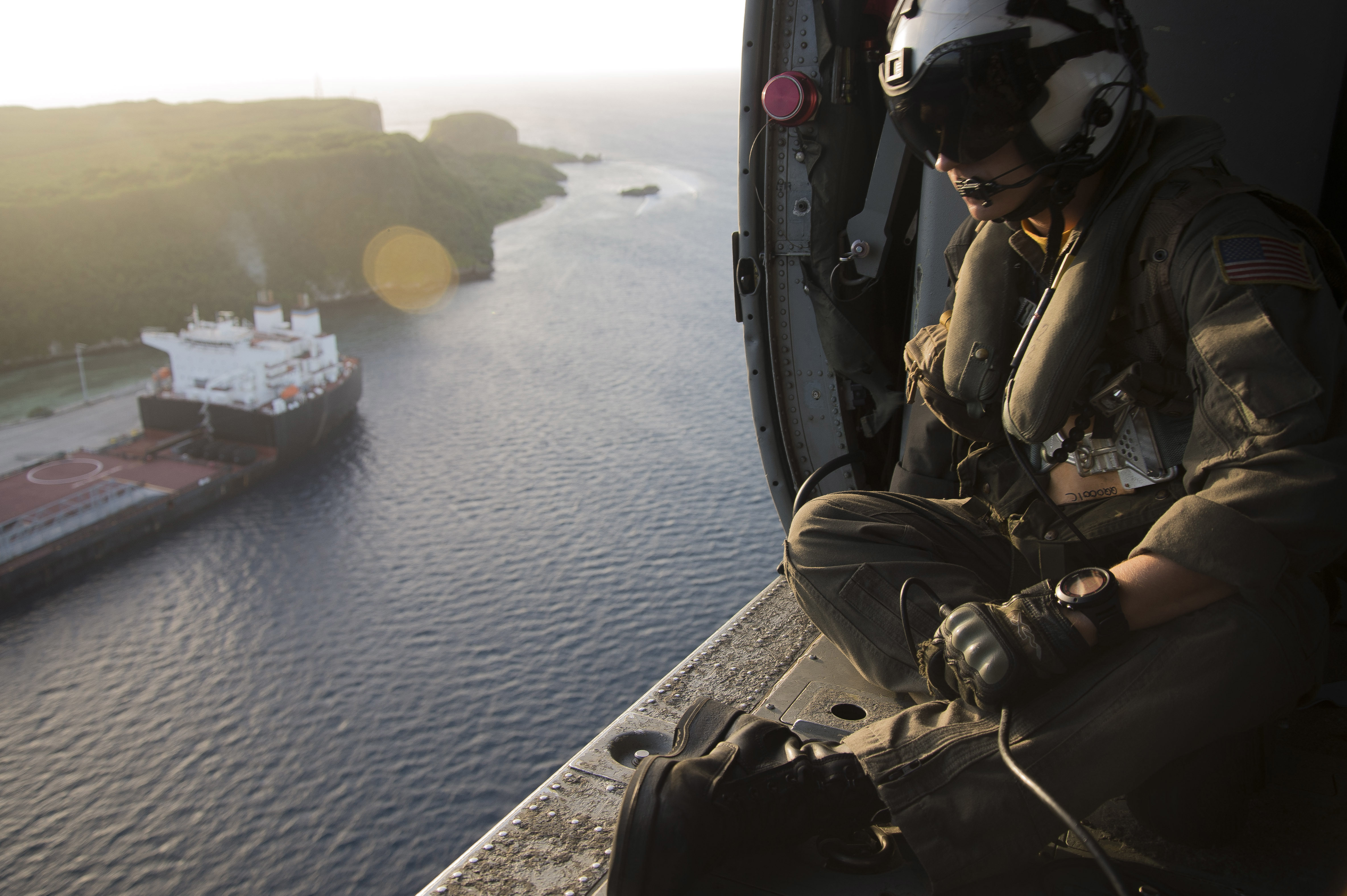U.S. Navy Naval Aircrewman (Helicopter) 1st Class John McCracken, assigned to Helicopter Sea Combat Squadron (HSC) 25, assists on overwatch during a Maritime Close Air Support Scenario with U.S. Marines in Guam. (Chief Mass Communication Specialist Joan E. Jennings/Navy)