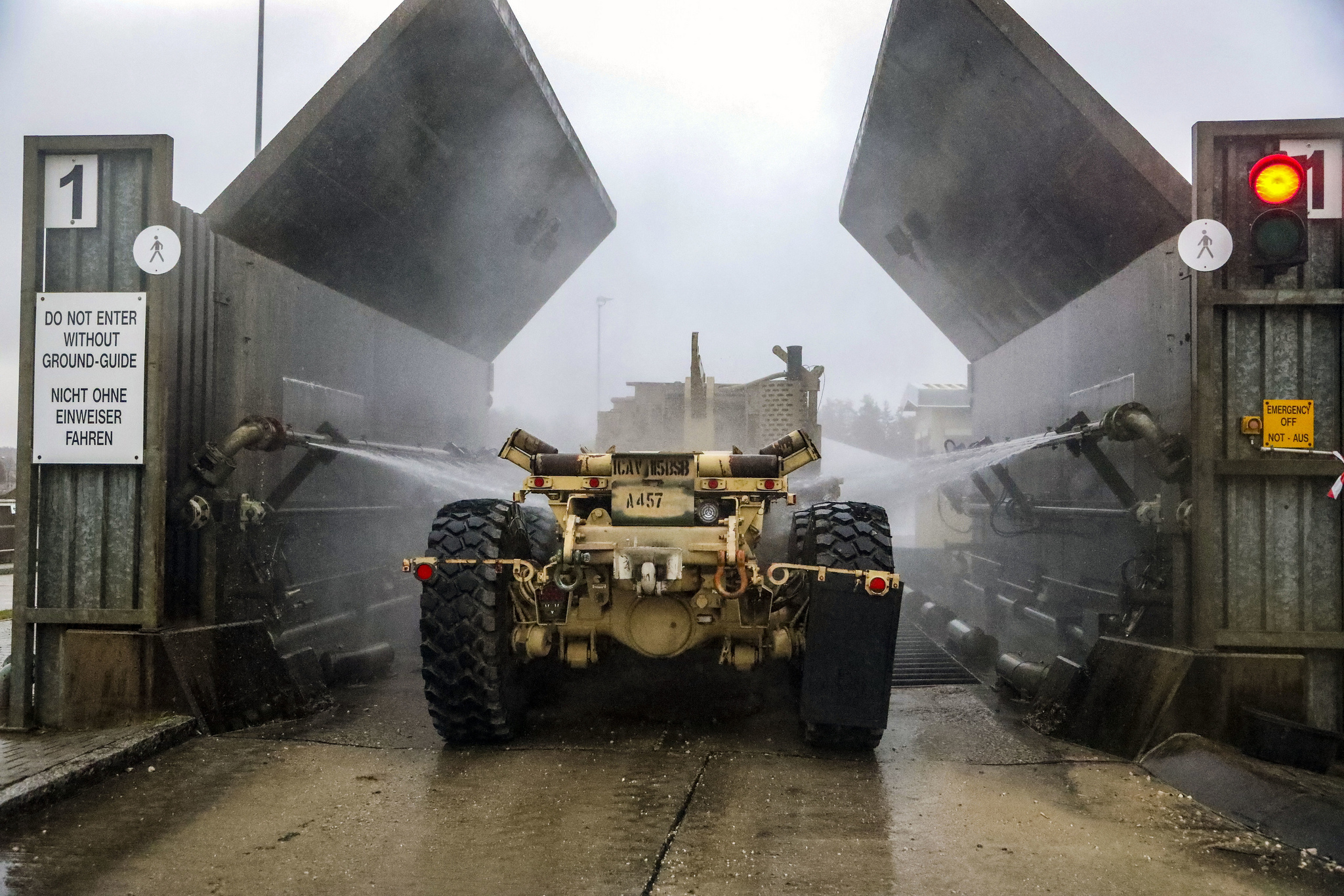 A soldier mans his vehicles as it is cleaned in the wash rack at Camp Aachen in Grafenwoehr, Germany Jan. 7, 2019. (Staff Sgt. Ron Lee/Army National Guard)