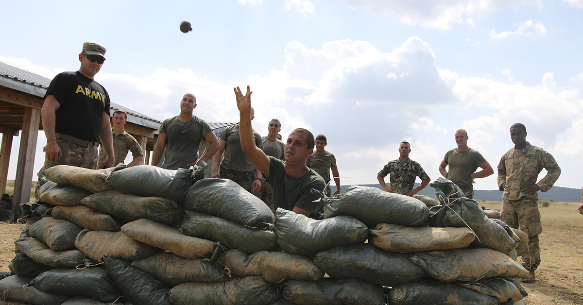 A Bulgarian Soldier assigned to 61st Mechanized Battalion, throws a training hand-grenade, during a team-building event of a spur ride, Novo Selo Training Area, Sept. 7, 2018. The spur ride is a time-honored cavalry tradition that gives cavalry troops the opportunity to earn silver spurs by participating in a series of physical and mental challenges, which helps create camaraderie and build esprit de corps. (Sgt. Jamar Marcel Pugh/Army National Guard)