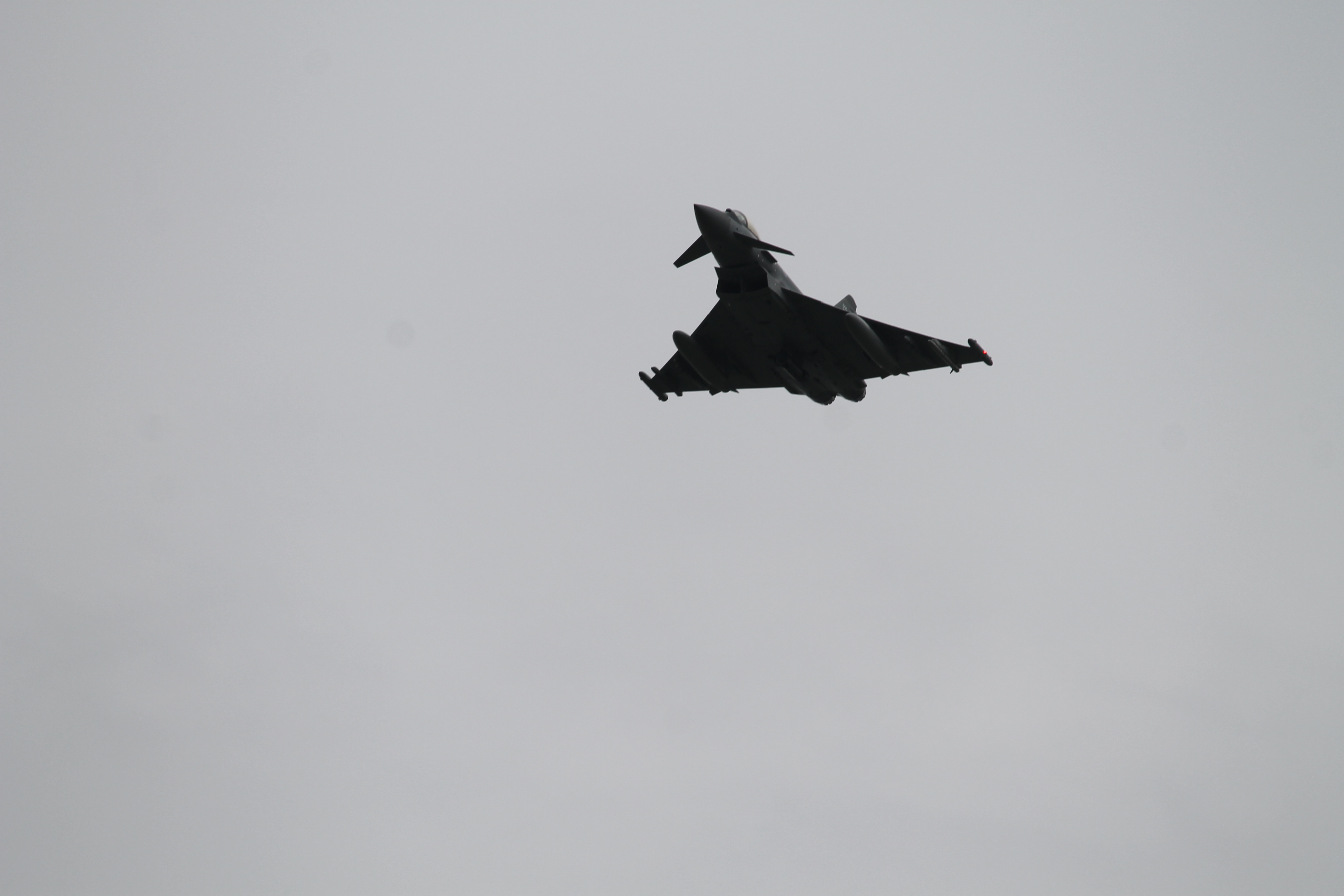A Eurofighter Typhoon jet soars over the bridge on the Danube. (Jen Judson/Staff)