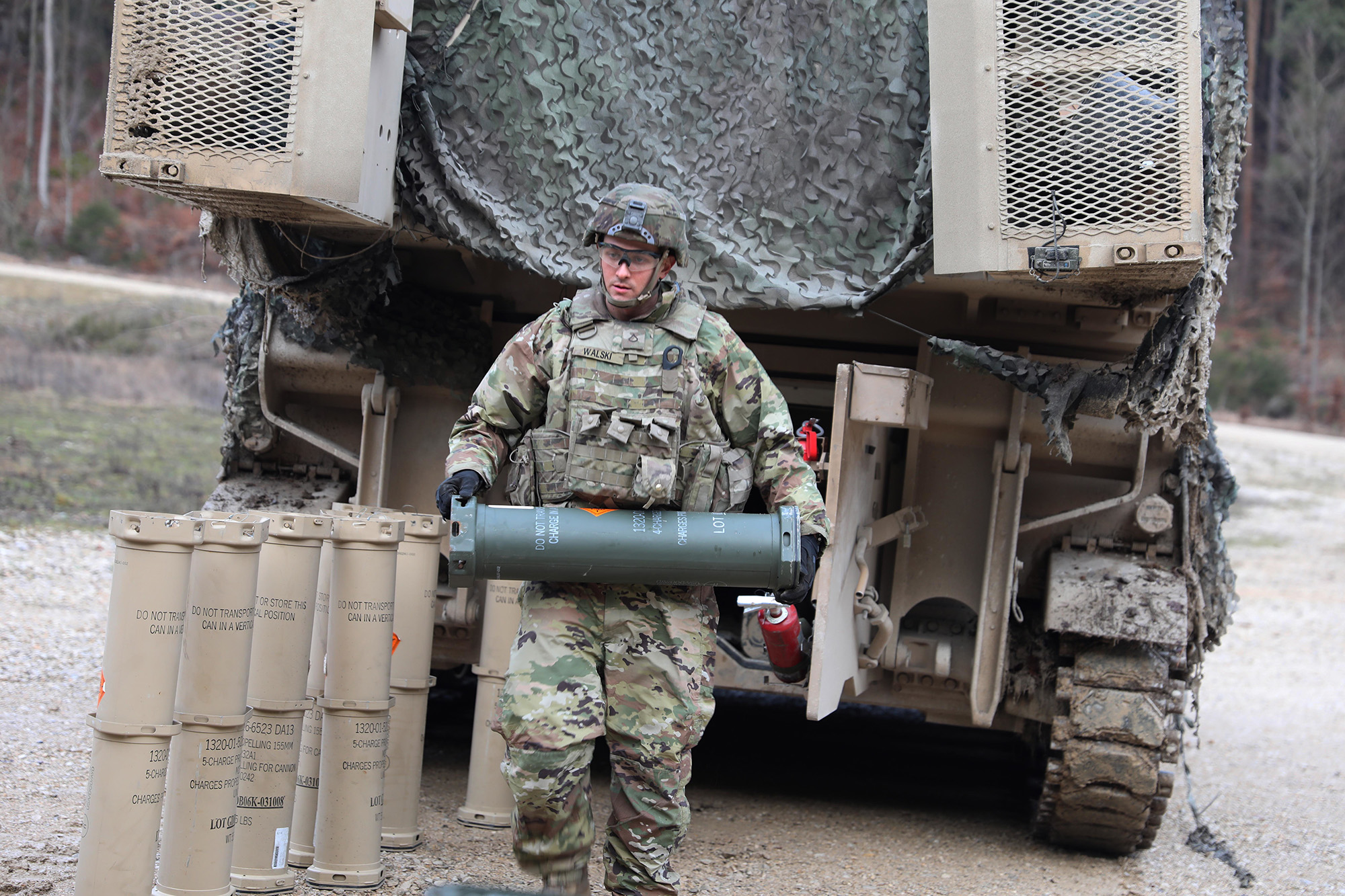 Pfc. Christopher Walski loads 155mm rounds into their Carrier, Ammunition Transport (CAT) in preparation of a Jan. 14, 2020, live-fire exercise in Grafenwoehr, Germany. (Sgt. Megan V. Zander/Army National Guard)