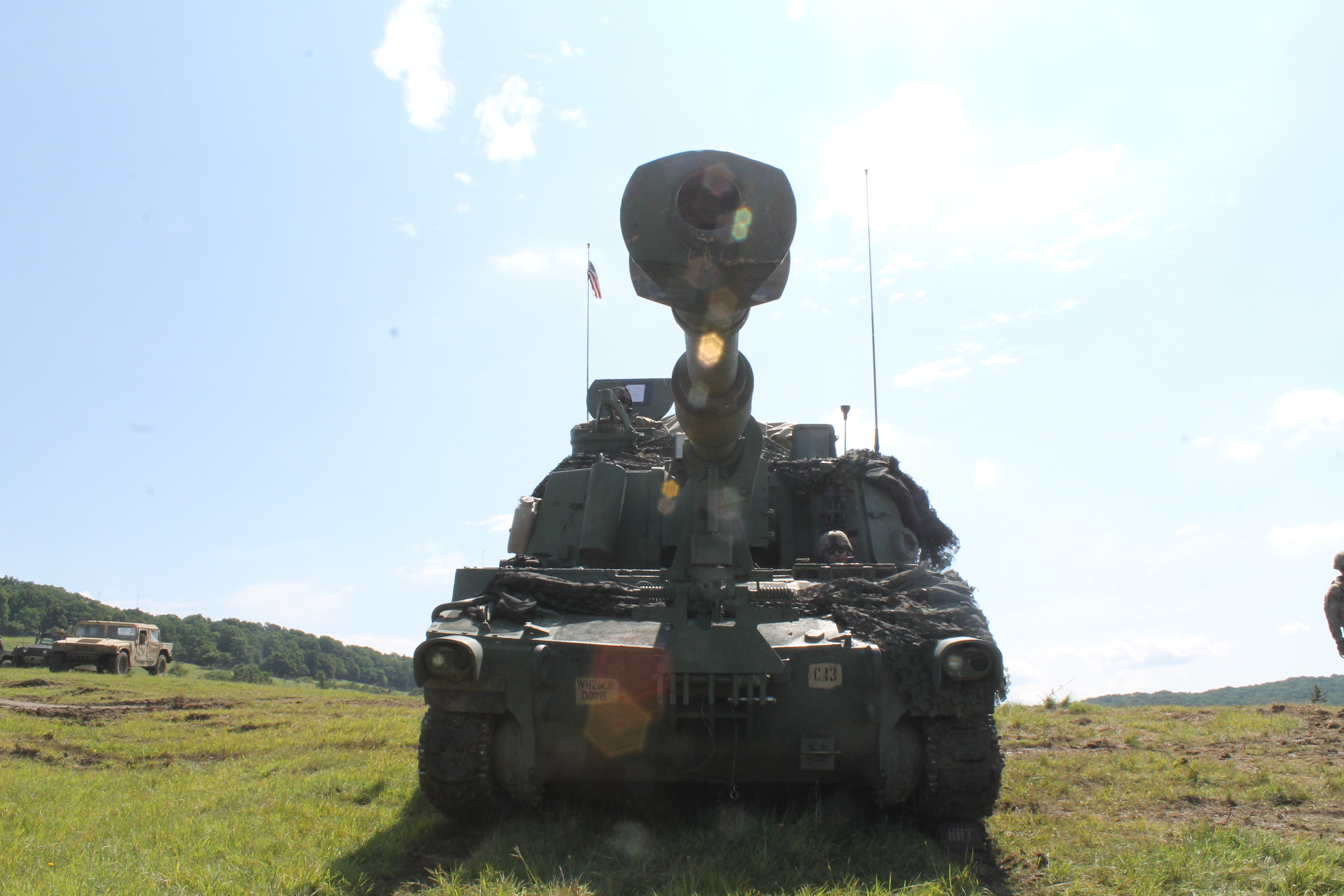 A Paladin howitzer sits atop a hillside waiting for the Super Bowl of live-fire exercises. The Paladin platoons eagerly awaited the big event for a chance to unleash major firepower. A total of 18 Paladins lined the hills of the exercise, firing from the location. The Army’s Paladins were joined by Romanian 125mm guns. Because the Paladins are more mobile, they required less camouflage than the 125mm guns that are stationary. Paladin operators said it was a great opportunity to work with the Romanians and learn how to operate in difficult, hilly, forested and often muddy terrain with large vehicles. (Jen Judson/Staff)