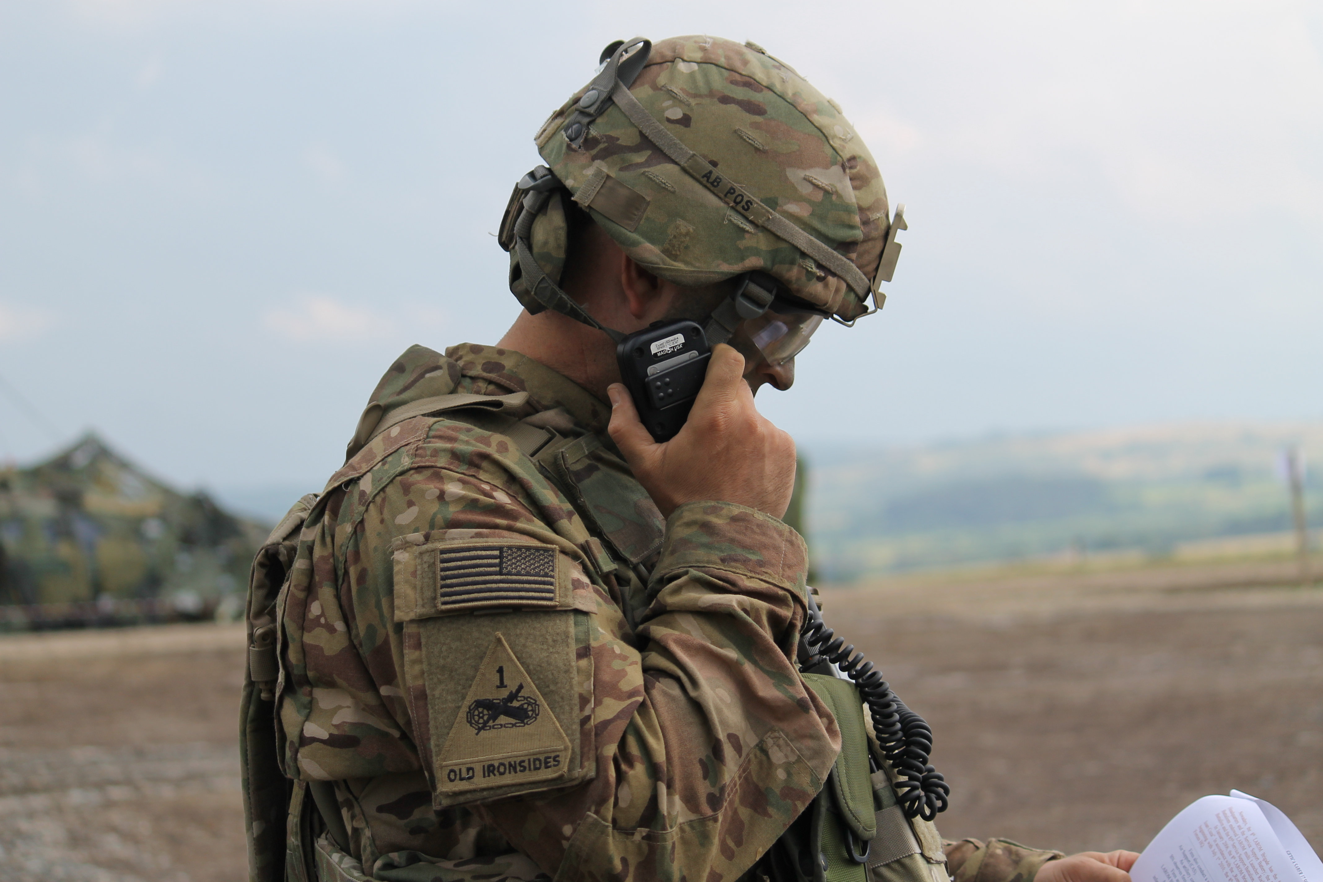 A U.S. Army soldier works behind the scenes at a rehearsal for the main event to communicate the order of the exercise to units involved. The intricate exercise includes a task force consisting of Romanian, Croatian, Armenian, Montenegrin, Ukrainian and U.S. mechanized infantry. It also includes Romanian and U.S. aviation, field artillery and air defense, as well as Romanian fighter jets. (Jen Judson/Staff)