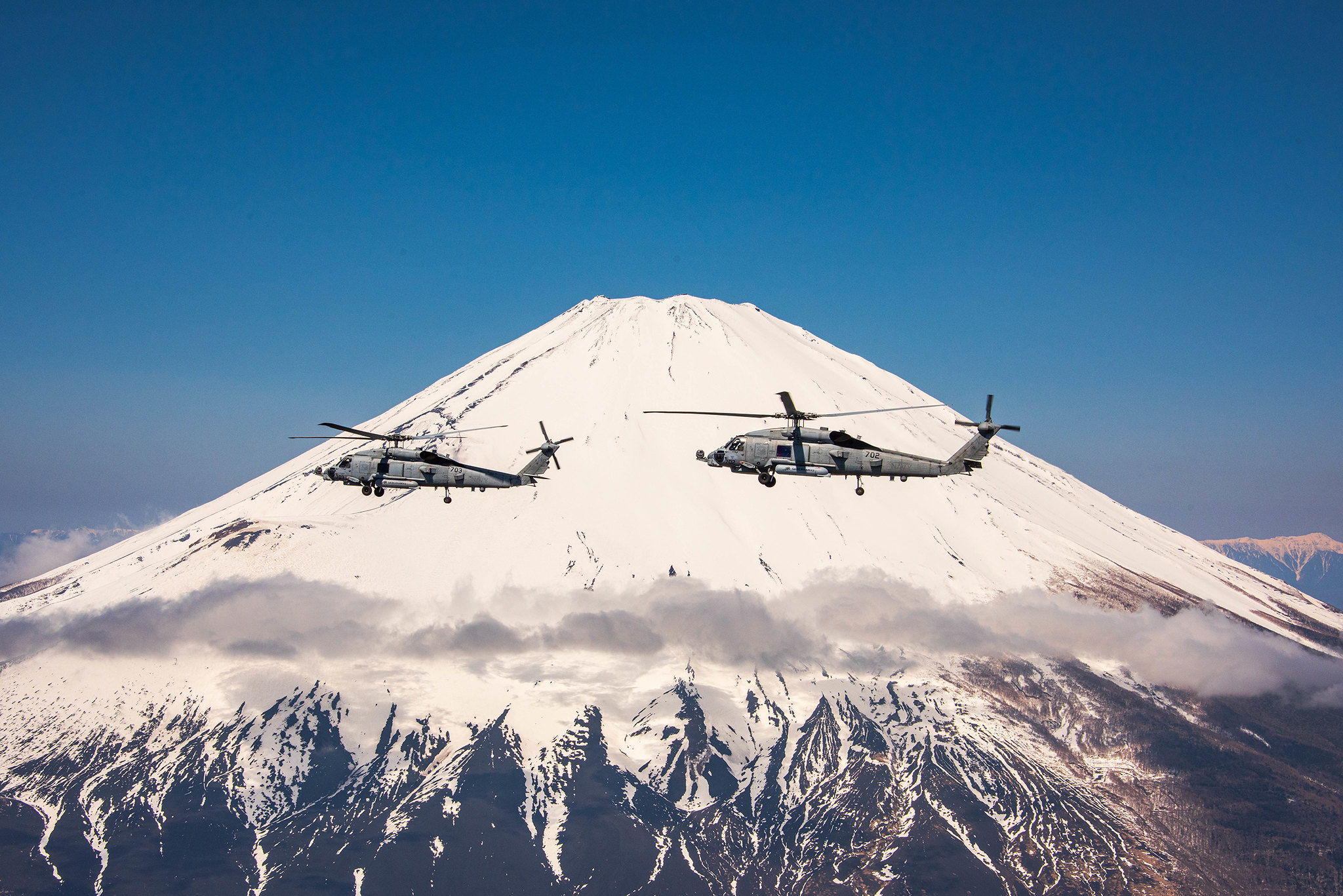 The “Saberhawks” of Helicopter Maritime Strike Squadron (HSM) 77 hold an airborne change-of-command ceremony departing from Naval Air Facility Atsugi, Japan, on April 25, 2020.(Seaman Apprentice Rafael Avelar/Navy)