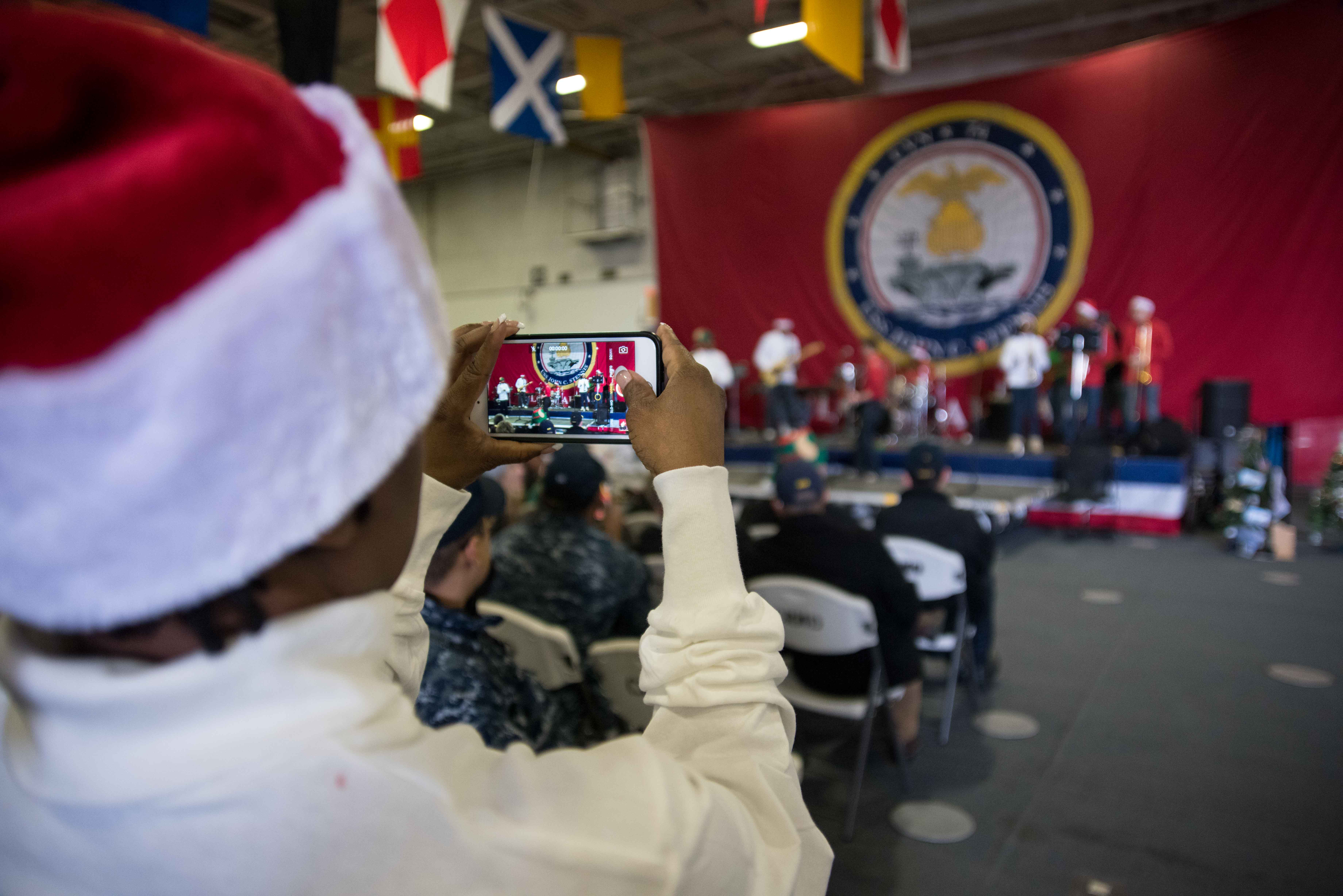 Sailors assigned to the aircraft carrier USS John C. Stennis participate in a holiday event held by the ship's crew in the hangar bay. U.S. Navy photo by Class William Ford