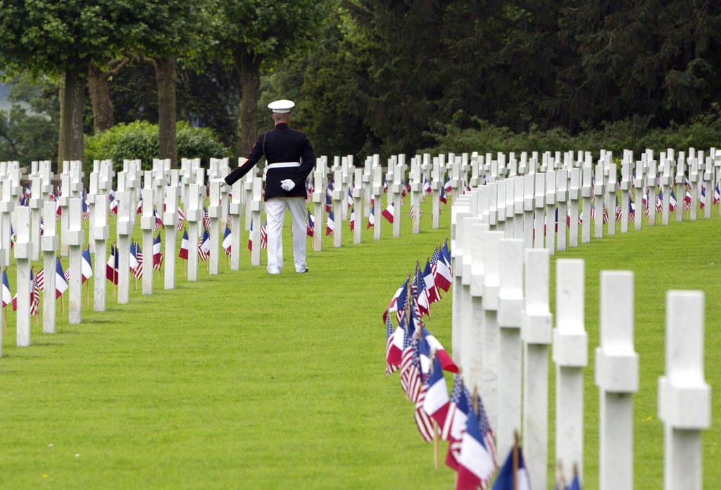 U.S. Marine Corps Sgt. Maj. Darrell Carver touches a headstone as he walks prior to a Memorial Day commemoration at the Aisne-Marne American Cemetery in Belleau, France, Sunday, May 27, 2018. The cemetery contains more that 2,000 American dead. (Virginia Mayo/AP)