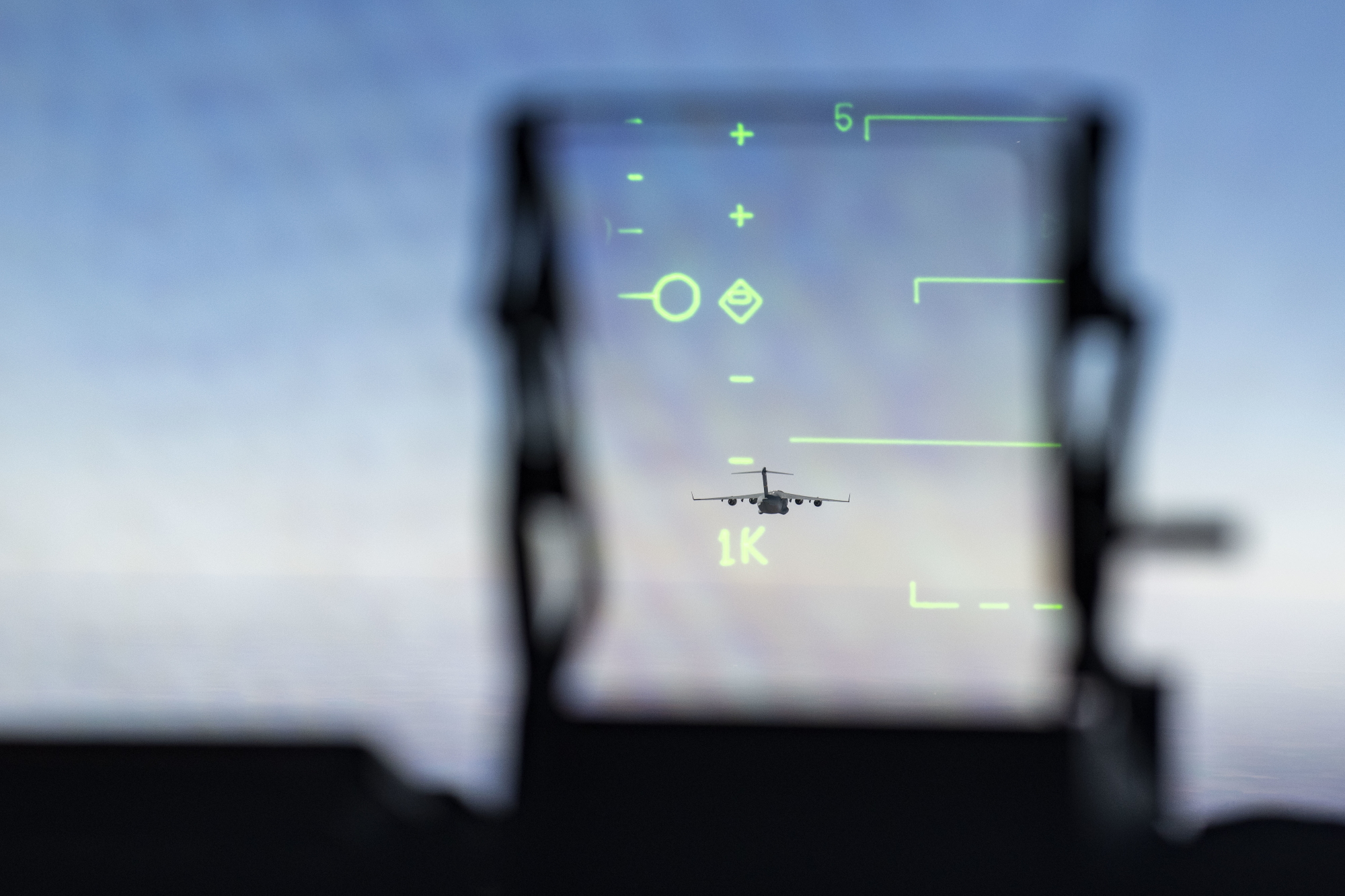 A C-17 Globemaster III is seen through the windshield of a second C-17 while in a three-aircraft formation at Altus Air Force Base, Okla., Nov. 5, 2019. (Airman 1st Class Breanna Klemm/Air Force)