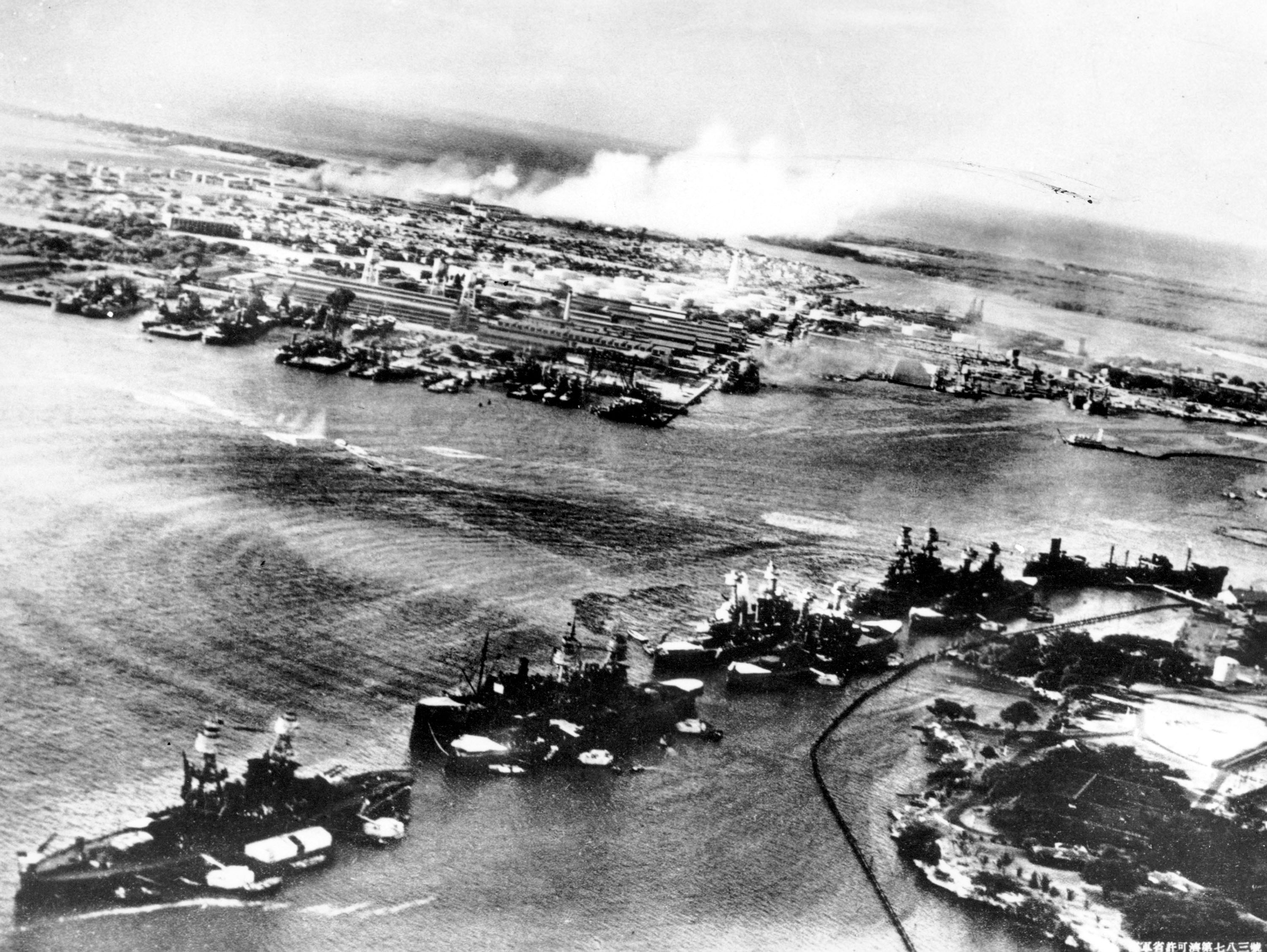 This picture, taken by a Japanese photographer, shows how American ships are clustered together before the surprise Japanese aerial attack on Pear Harbor, HI., on Sunday morning, Dec. 8, 1941. Minutes later the full impact of the assault was felt and Pearl Harbor became a flaming target. (AP Photo)