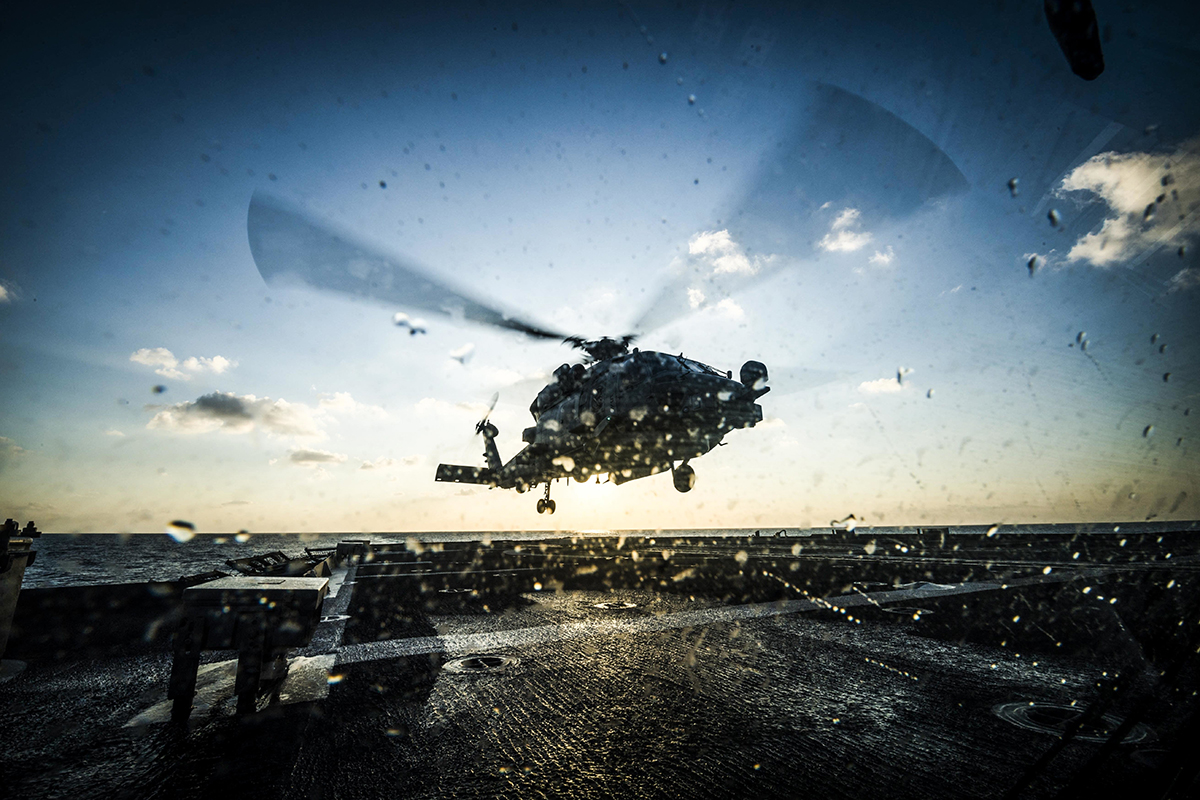 An MH-60R Sea Hawk helicopter takes off from the flight deck of the Ticonderoga-class guided-missile cruiser USS Chancellorsville (CG 62) on Nov. 14, 2018, during flight quarters in the Philippine Sea. (MC2 Sarah Myers/Navy)