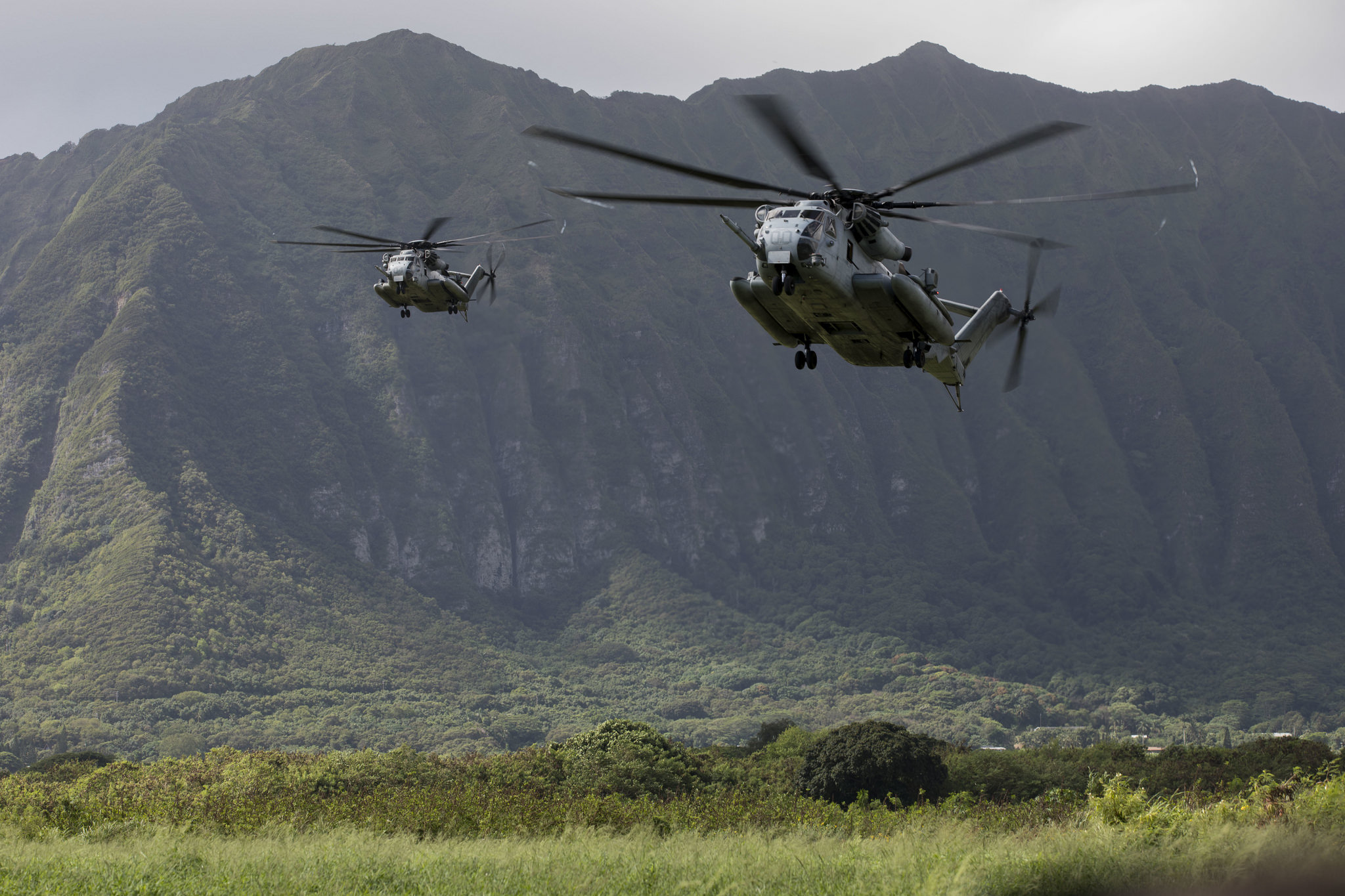 U.S. Marine Corps CH-53E Super Stallions prepare to land and drop off U.S. Marines on Sept. 18, 2018, during a helicopter insertion exercise at Marine Corps Training Area Bellows (MCTAB), Hawaii. (Sgt. Jesus Sepulveda Torres/Marine Corps)