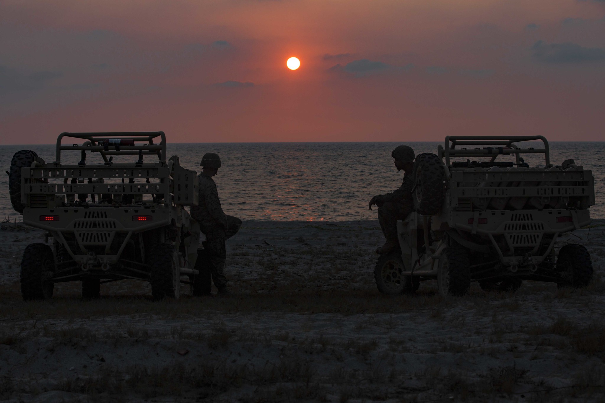 Marines sit on their Utility Terrain Vehicles observing the sunset April 7, 2019, after a training event at the Navy Education and Training Command, Philippines, during Exercise Balikatan. (Lance Cpl. Christian Ayers/Marine Corps)