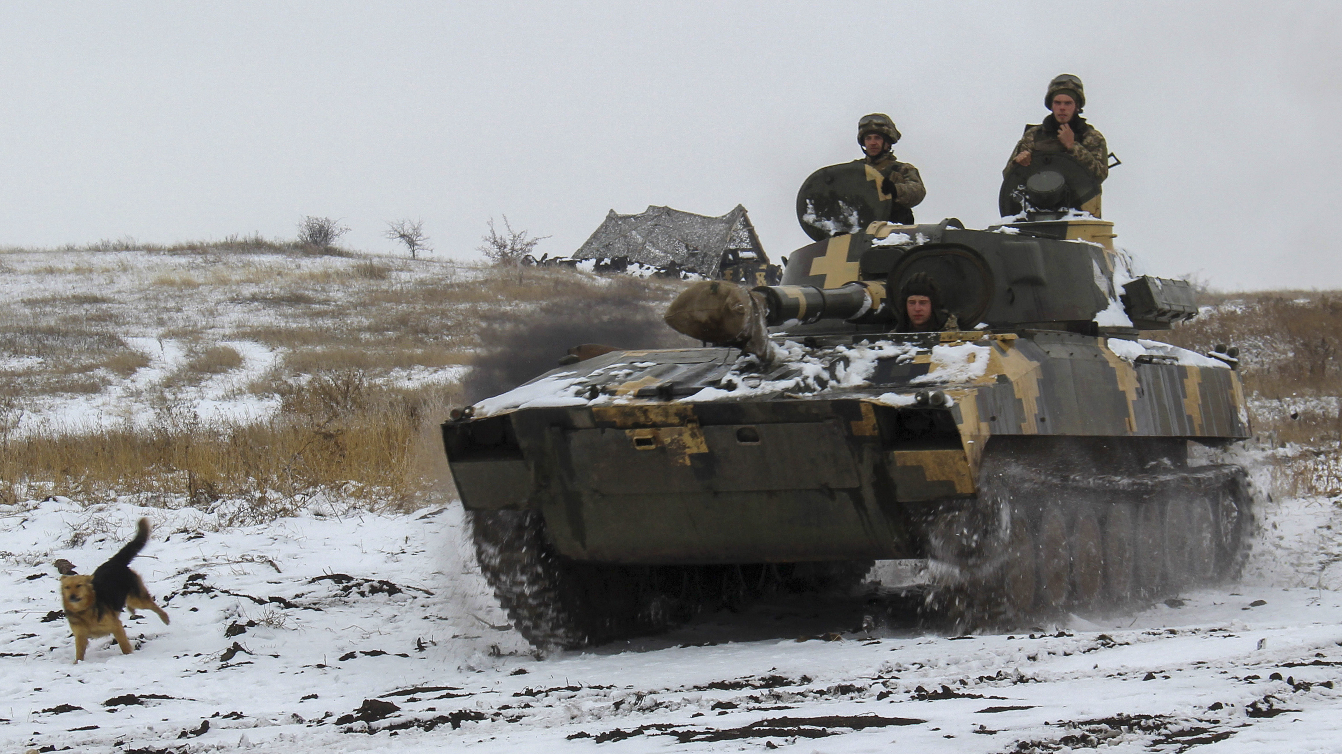 A Ukraine army APC moves toward on position at an undisclosed location in eastern Ukraine, Monday, Nov. 26, 2018. Ukrainian lawmakers were set to consider a presidential request for the introduction of martial law in the country on Monday following an incident in which Russian coast guard ships fired on Ukrainian navy vessels. (AP Photo/Alexander Shulman)