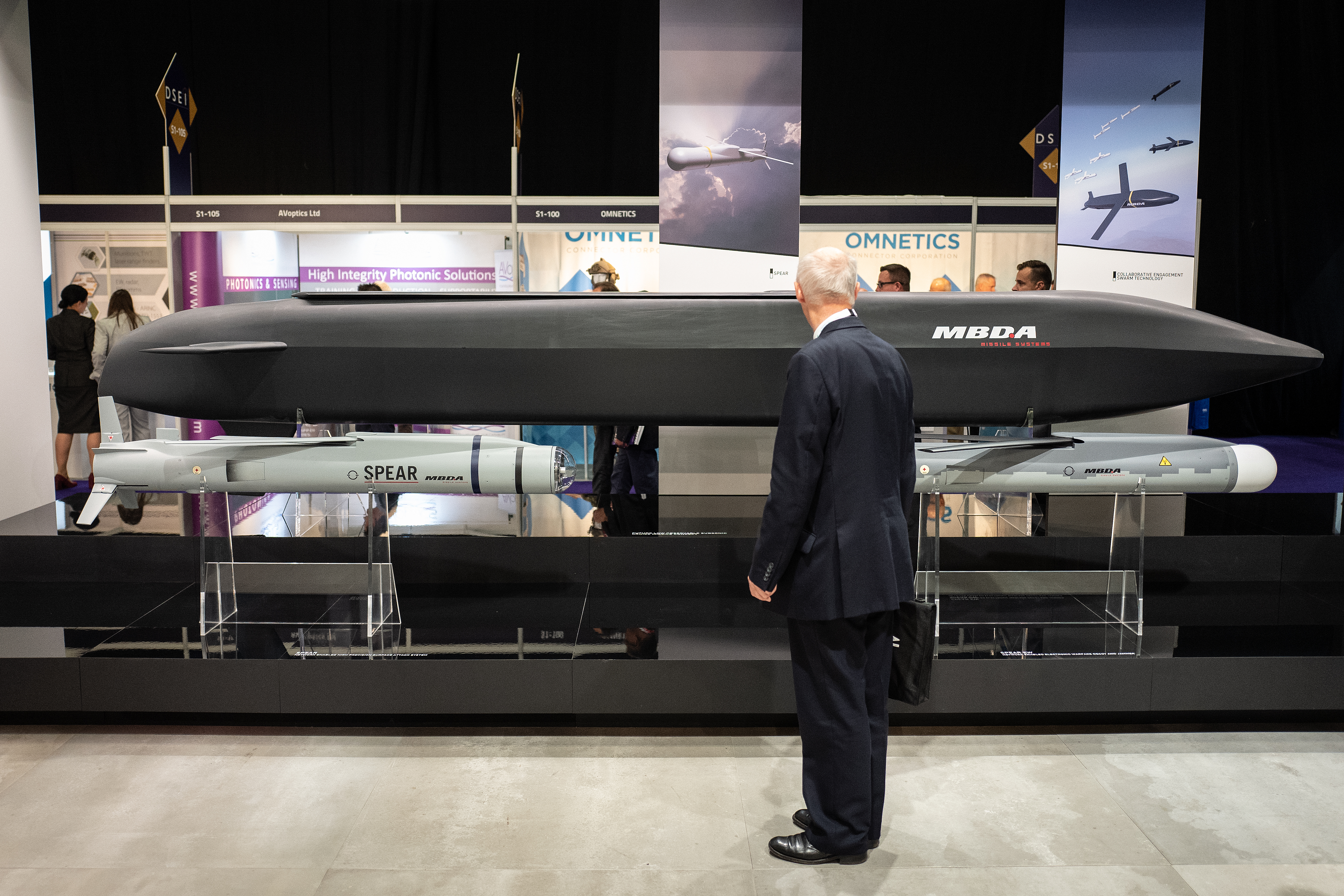 A delegate looks at the MBDA Spear network-enabled high-precision surface attack system left, a