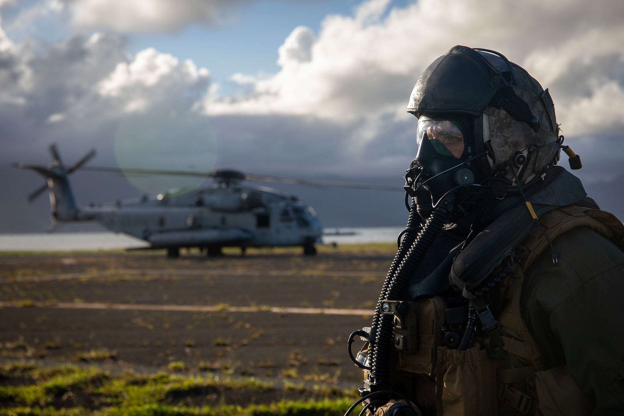 Maj. Ryan Pallas, a CH-53 Super Stallion helicopter pilot with Marine Heavy Helicopter Squadron (HMH) 463, stands by after donning his gas mask prior to a Helicopter Support Team (HST) exercise at Landing Zone Westfield, Marine Corps Base Hawaii. (Sgt. Zachary Orr/Marine Corps)