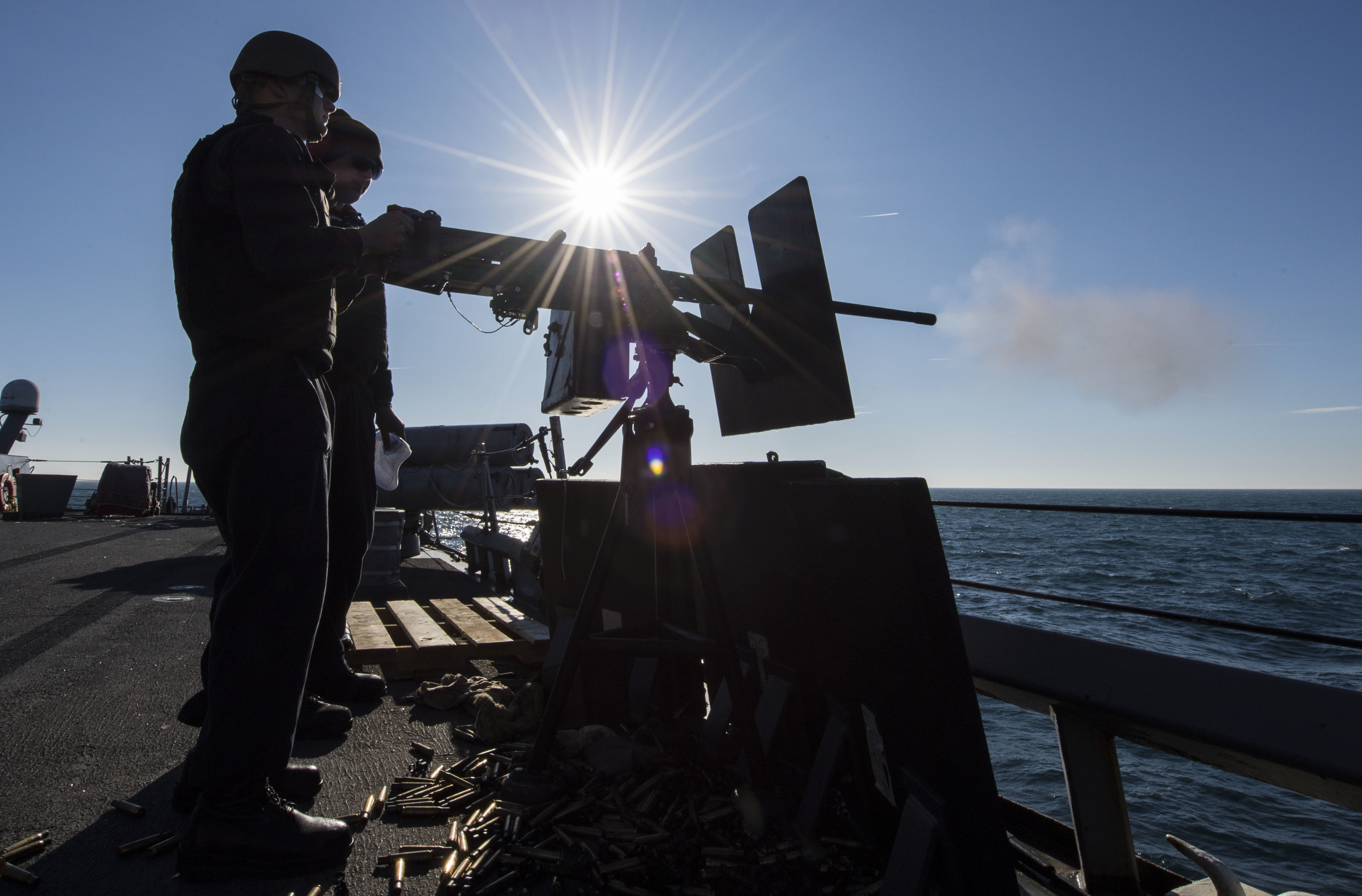 Sonar Technician (Surface) 2nd Class Jacob Ferrantino fires a .50-caliber machine gun aboard the Arleigh Burke-class guided-missile destroyer USS Carney during a live-fire exercise in the Black Sea, Jan. 6, 2018. (U.S. Navy photo by James R. Turner)