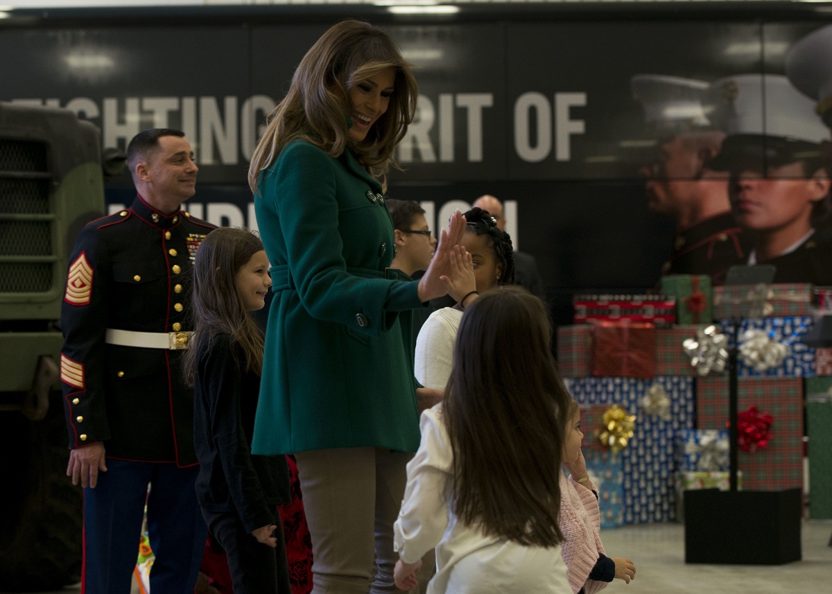 First lady Melania Trump high fives a child during the annual Marine Corps Foundation’s Toys for Tots event Dec. 13, 2017, on Joint Base Anacostia-Bolling. Trump helped children make cards, sorted toys and greeted military families at the event. (MC2 Jason Amadi/Navy)