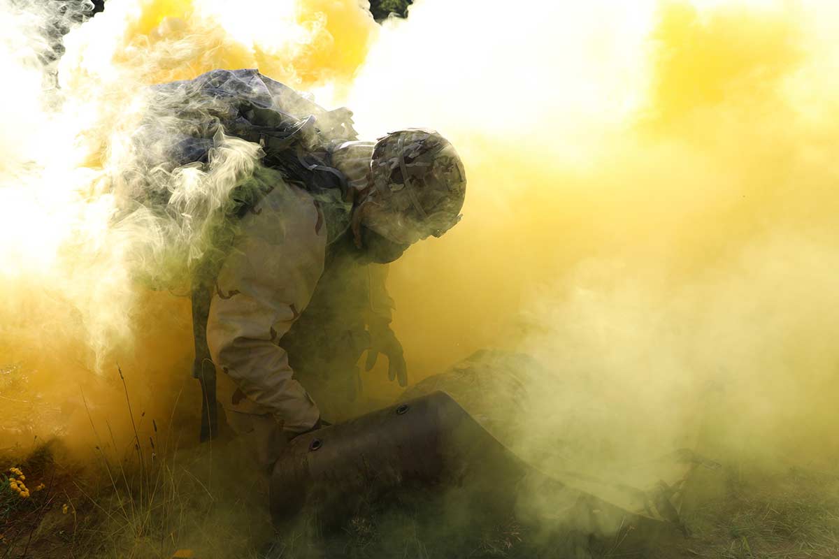 U.S. Army Sgt. 1st Class Christopher Moore secures a simulated casualty on a sked while under a simulated chemical, biological, radiological and nuclear attack during the 21st Theater Sustainment Command Best Medic Competition in Baumholder, Germany, Aug. 22, 2019. (Sgt. Jesse Pilgrim/Army)