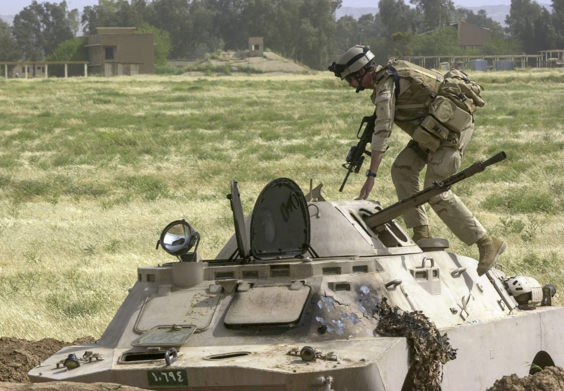 Staff Sgt. Dan Hunter, from Georgia, a member of a U.S. Air Force Global Airfield Assesment Team (GAAT) from McGuire AFB in New Jersey, checks to make sure that an Iraqi armored vehical was clear while surveying a captured Iraqi Helicopter/Air Base on the outskirts of Kirkuk. The GAAT team measured and tested the quality of the runways and parking ramps to see if they could support the weight of heavy aircraft for use by the US military. (Alan Lessig/Air Force Times)