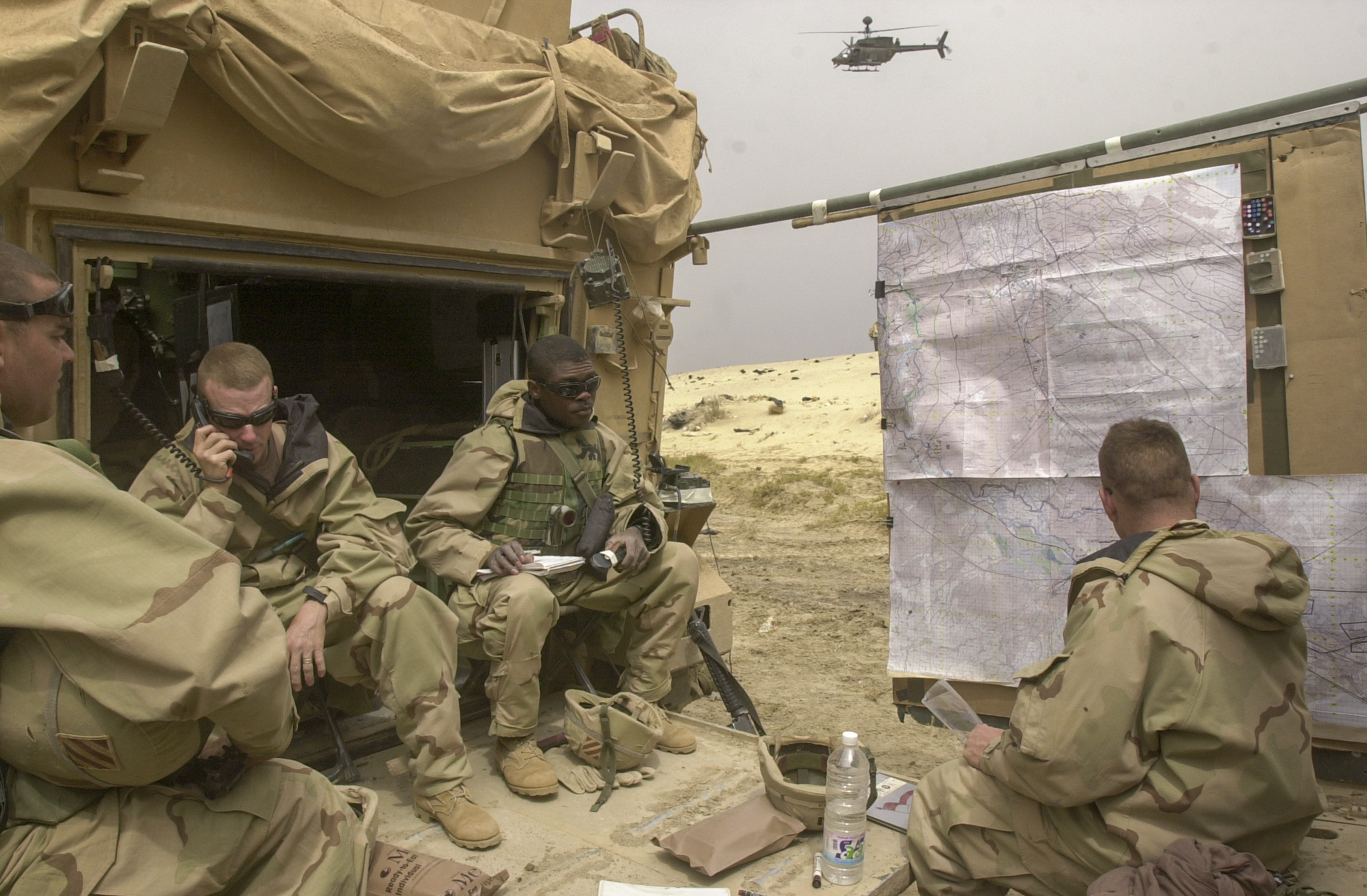 03/24/03 As Samawah, Iraq Soldiers from the Headquarter's element of the U.S. Army's 7th Cavalry Regiment co-ordinate the battle from their makeshift Tactical Operations Center, just outside the city of As Samawah. The Cavalry has been fighting in and around the town for more than 48 hours, facing at times strong resistance from the more than 1,500 fighters inside. (Warren Zinn/Army Times)