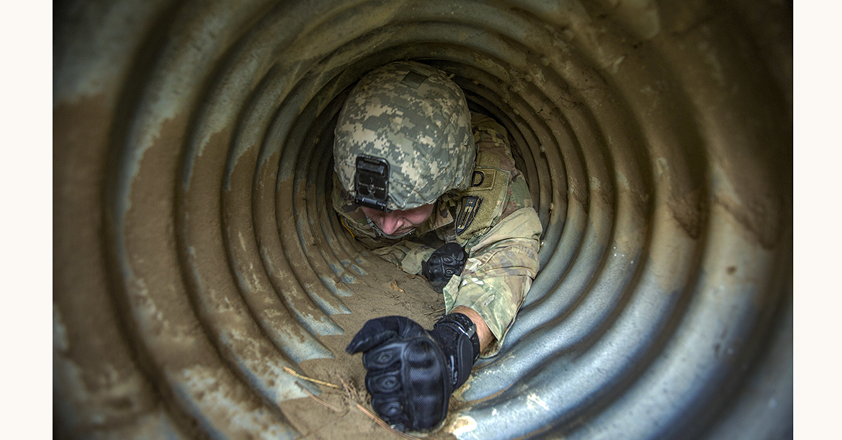 Army Reserve Spc. Alex Thompson, 376th Engineer Firefighter Detachment, crawls through a tube for confined space familiarization training during Combat Support Training Exercise (CSTX) 86-18-02 at Fort McCoy, Wis., August 13, 2018. (Spc. John Russell/Army)