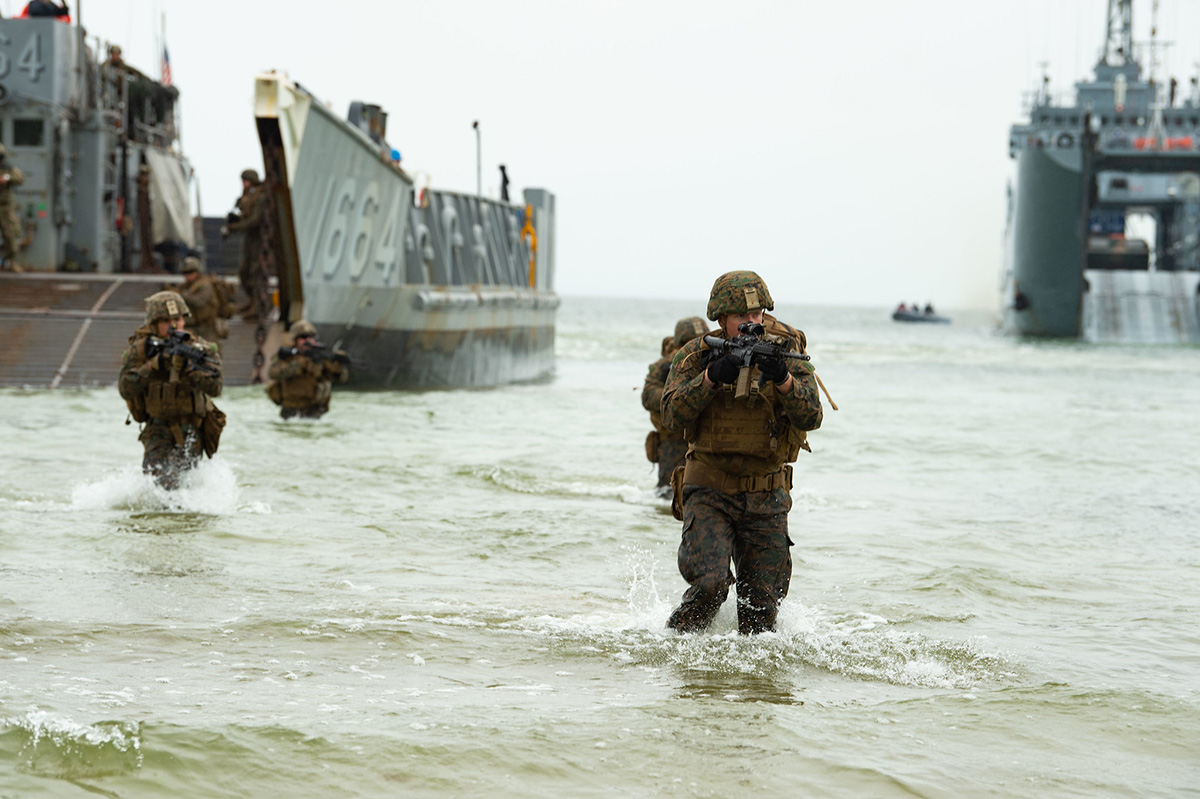 U.S. Marines wade ashore from a landing craft, utility on June 16, 2019, during an amphibious assault for exercise Baltic Operations (BALTOPS) 2019 in Klaipeda, Lithuania. (Mass Communication Specialist 3rd Class Jack D. Aistrup/Navy)