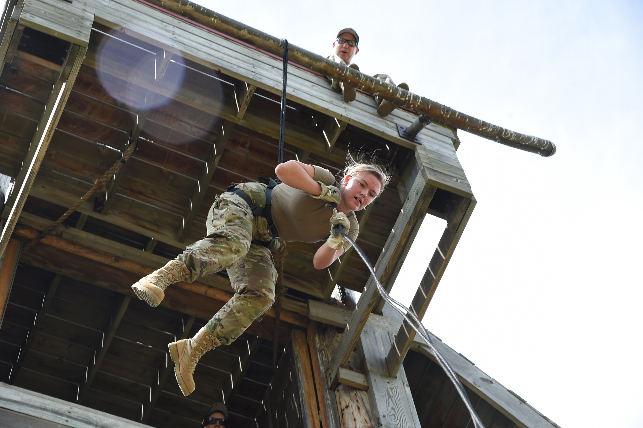 Airman 1st Class Maggie Hebert lowers herself on a rope using an