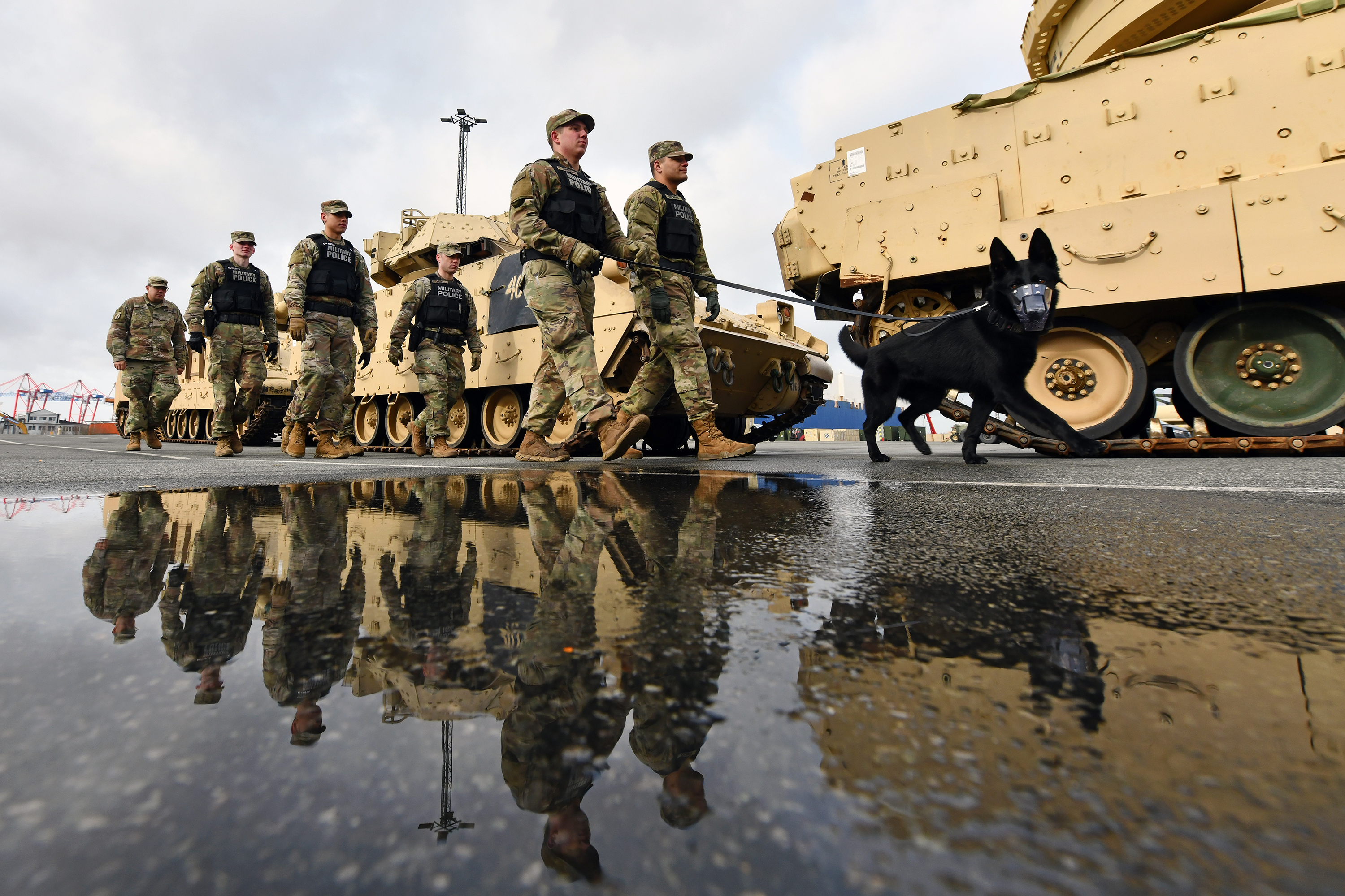 U.S. soldiers assigned to 527th Military Police Company, 615th Military Police Company and 100th Military Working Dog Detachment conduct security rounds at Bremerhaven Port, Bremerhaven, Germany, on Feb. 21, 2020. (Jason Johnston/Army)