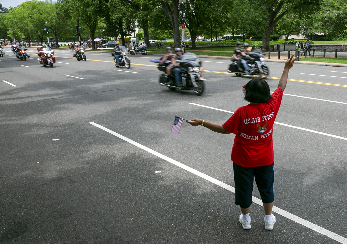 Air Force veteran Anna Sanders from Baton Rouge, LA, shows her support to riders during Rolling Thunder XXXI First Amendment Demonstration Run along Constitution Ave. in Washington, DC on Sunday May 27, 2018. Motorcycle riders from across the nation, rode a designated route through the Mall area of Washington, D.C. The event is an actual demonstration/protest to bring awareness and accountability for POWs and MIAs left behind.(Alan Lessig/Staff)