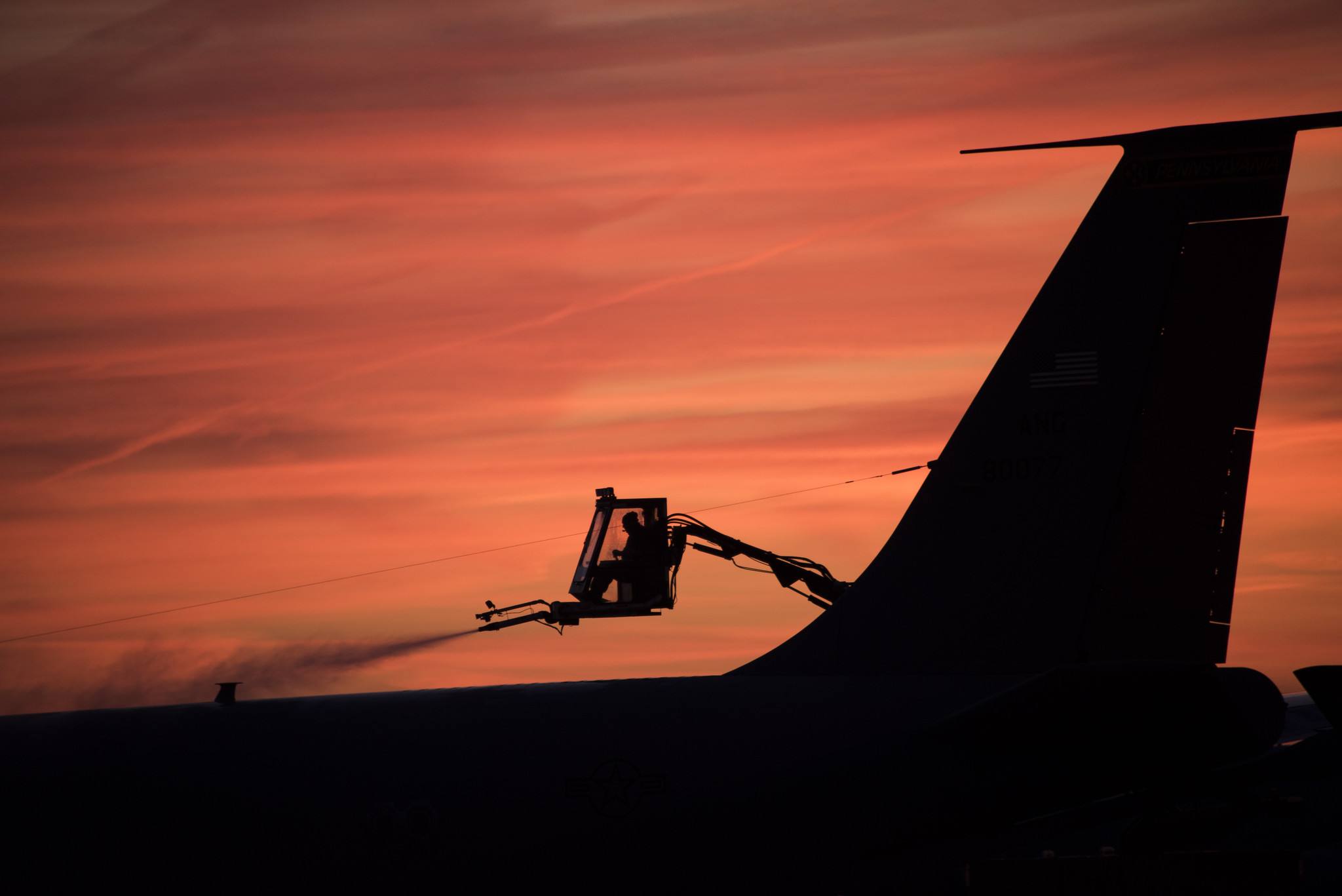 Tech. Sgt. Joshua Nordeen, a Pennsylvania Air National Guardsman, deices an aircraft early in the morning as the sun rises in Pittsburgh, Pa., on Dec. 12, 2019. (Staff Sgt. Bryan Hoover/Pennsylvania Air National Guard)