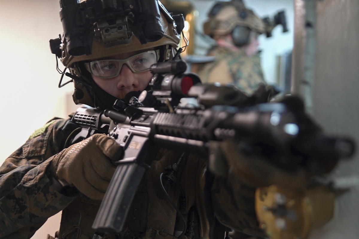 A force reconnaissance Marine provides security while clearing the ship June 29, 2019, during a visit, board, search and seizure exercise aboard the amphibious dock landing ship USS Ashland (LSD 48), underway in the Coral Sea. (Lance Cpl. Brennan Priest/Marine Corps)