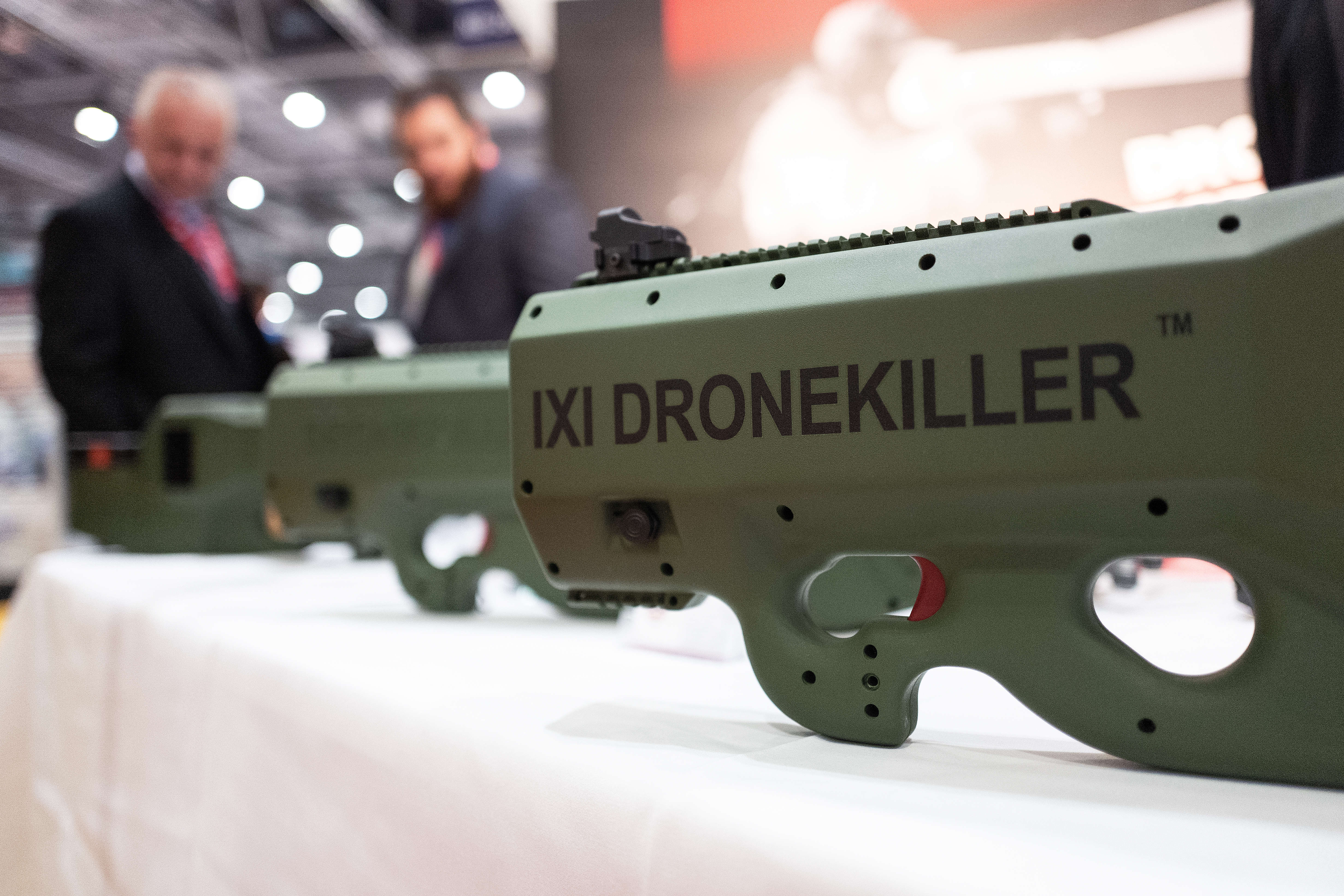 On the opening day of the DSEI arms fair, delegates look at the IXI Dronekiller system. (Leon Neal/Getty Images)