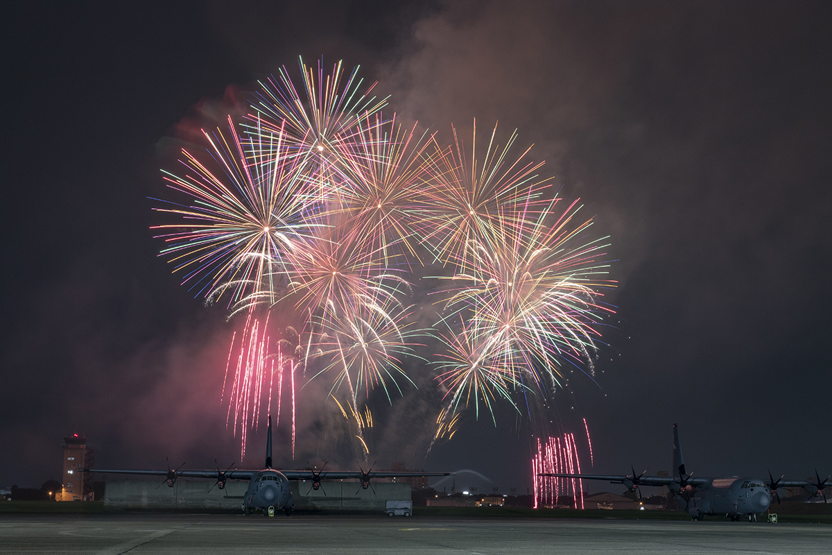 Fireworks explode behind a C-130J Super Hercules during Celebrate America at Yokota Air Base, Japan, July 3, 2019. (Airman 1st Class Brieana E. Bolfing/Air Force)